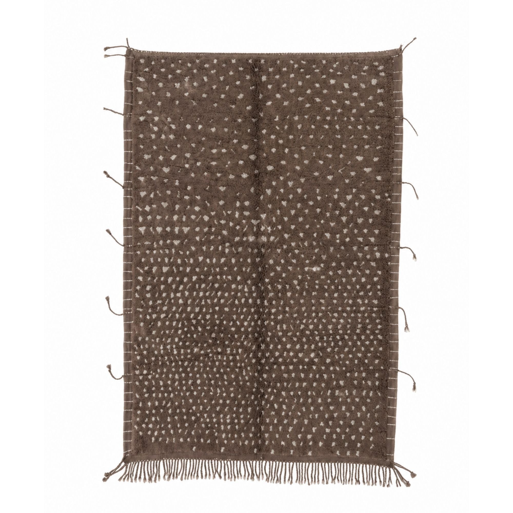 Atelier No. 01 handmade Moroccan wool rug in warm brown with ivory dotted pattern and braided tassels on neutral background.