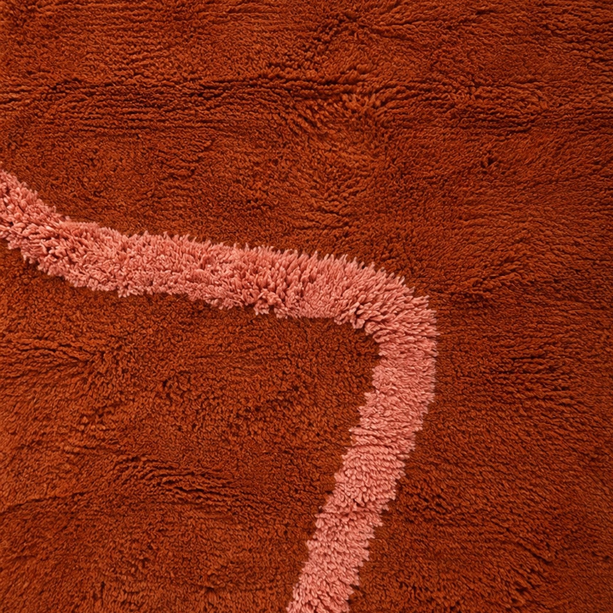 Blush pink abstract line detail on handmade terracotta Moroccan wool rug