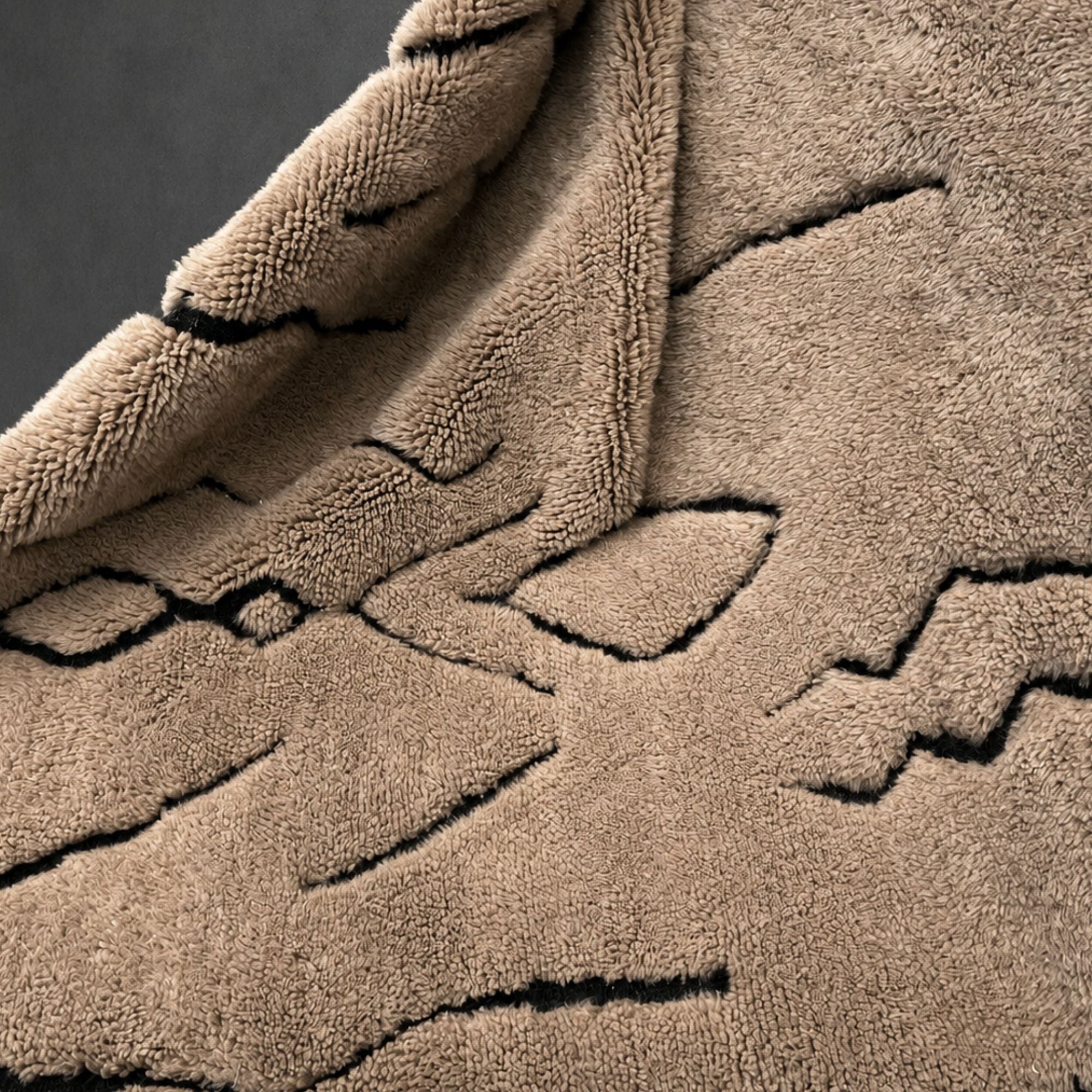 Close-up of Tracks Moroccan wool rug showing high-pile texture and black line detailing.