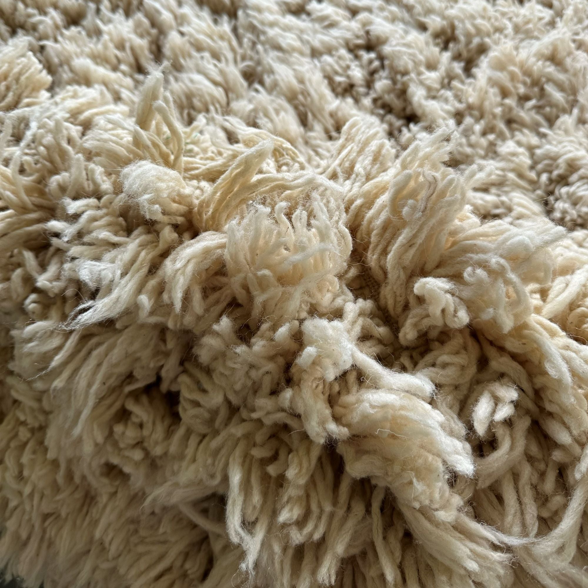 Close-up of Halo Round Rug showing dense shaggy wool pile and cloud-like handmade texture crafted from natural Moroccan wool.
