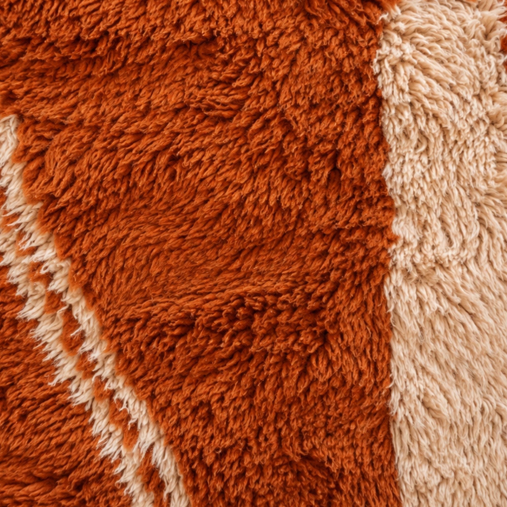 Close-up of Sienna terracotta Moroccan rug showing soft natural wool pile and ivory geometric pattern