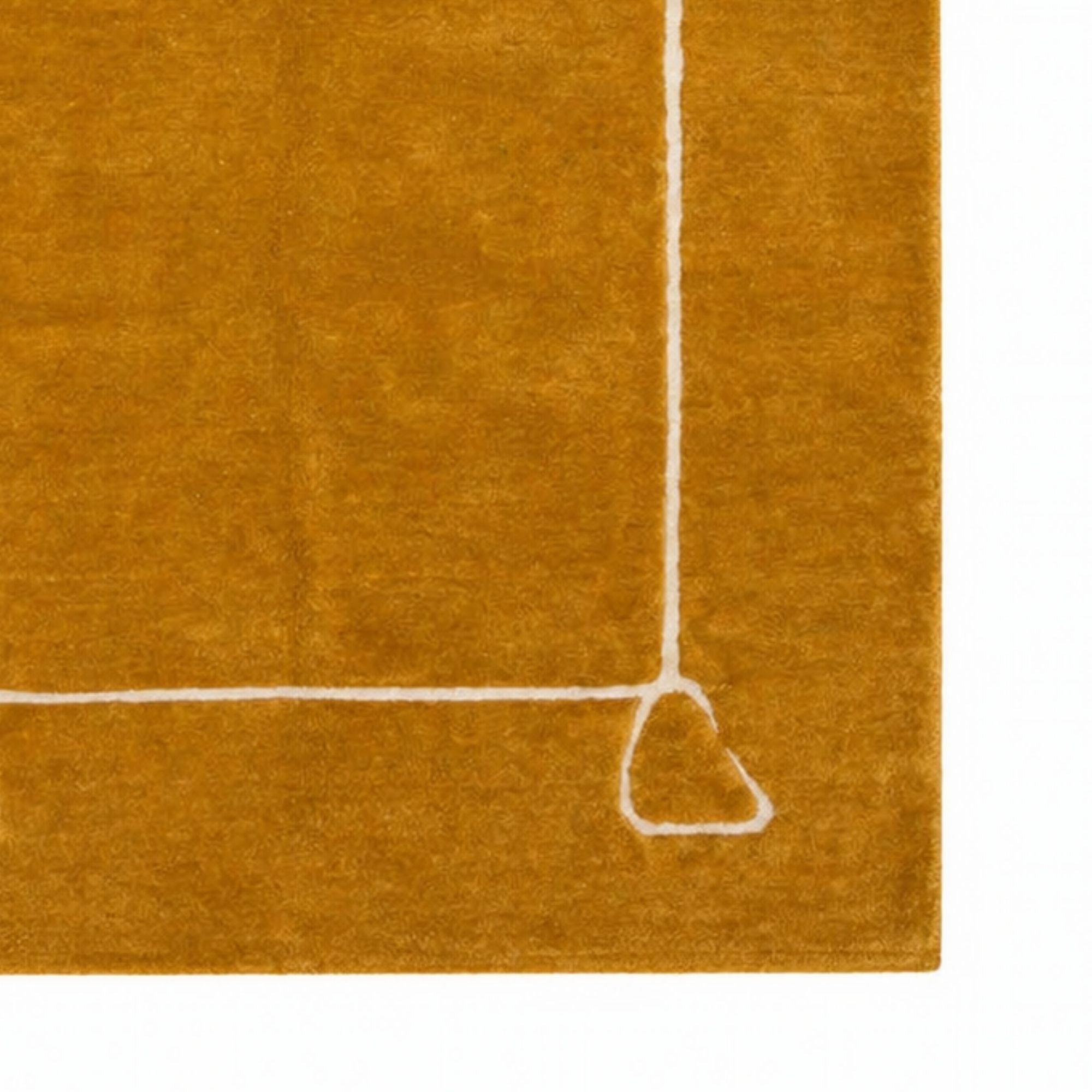 Close-up of saffron wool Moroccan rug with ivory line detail, high pile texture, handcrafted Berber rug