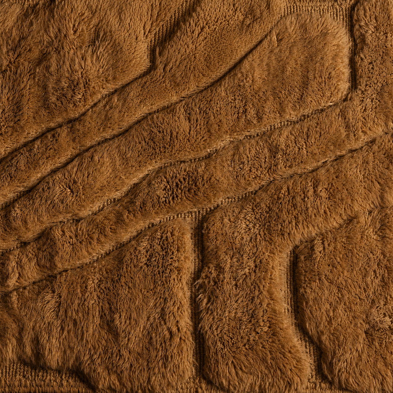 Detailed view of Relief No. 01 sculptural Moroccan runner rug featuring raised geometric relief motifs, luxurious high-pile wool texture, and warm camel brown coloration inspired by natural landforms.