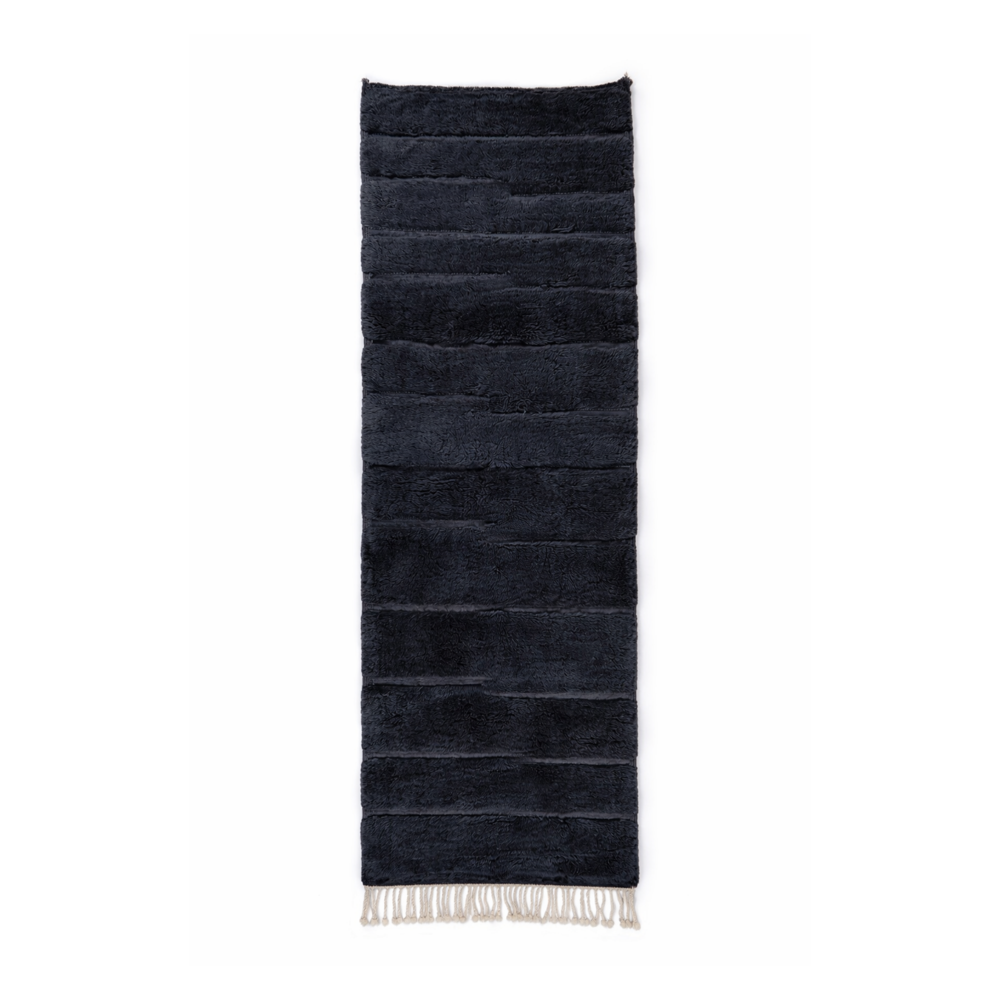 Handmade Moroccan runner rug in deep navy wool with subtle linear texture and ivory tassels on neutral background.