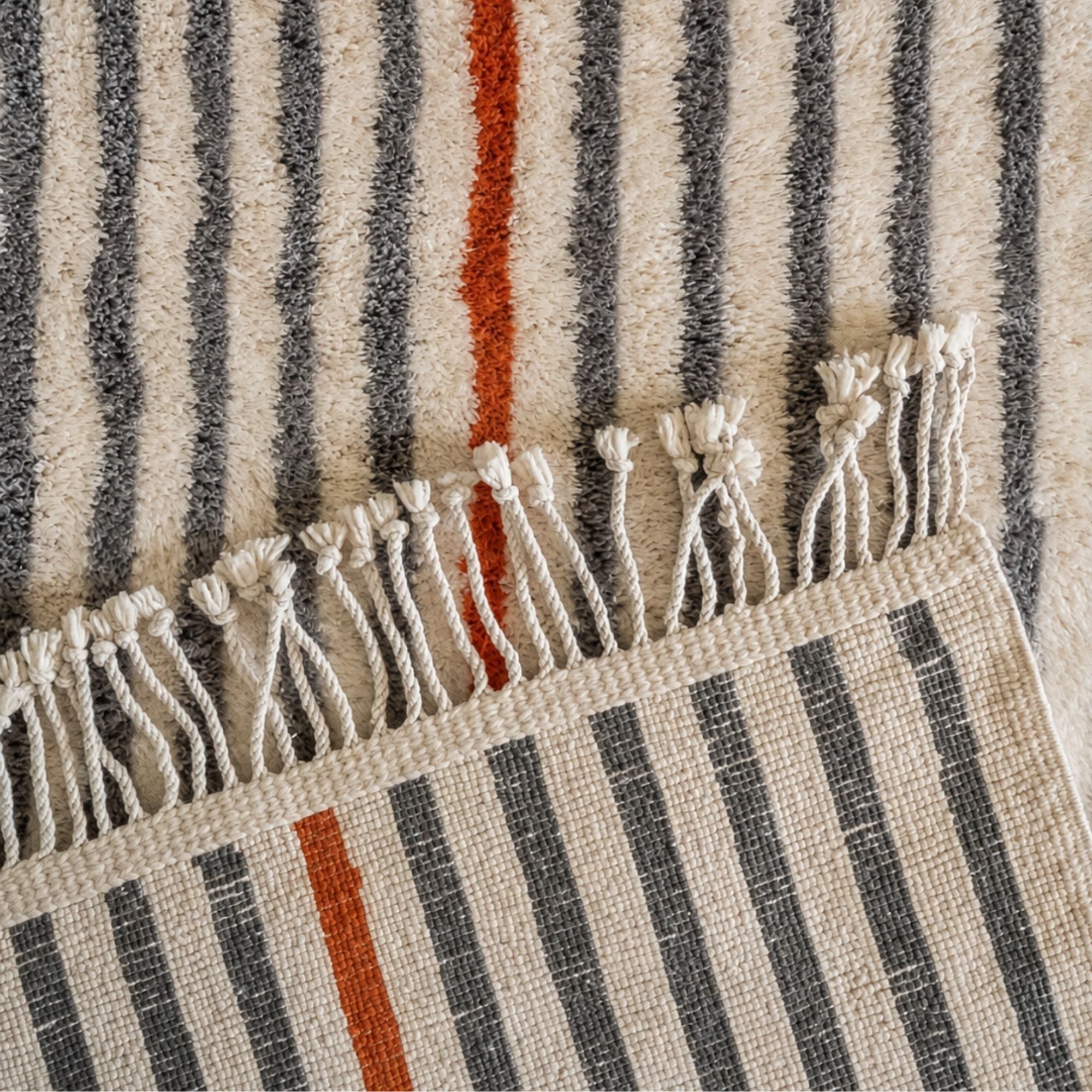 Handmade Moroccan wool rug with grey stripes, terracotta accent and hand-finished fringe