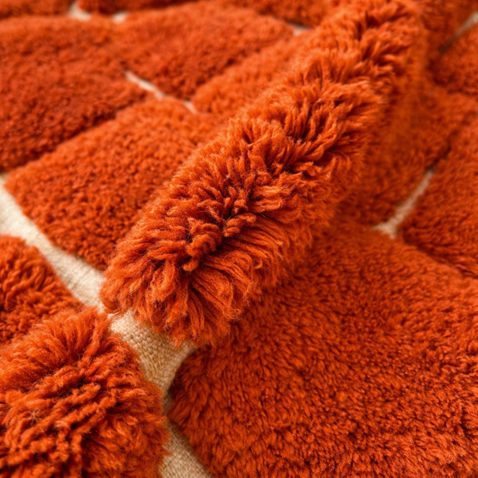 Handwoven Moroccan wool rug, Kiln design, close-up of hand-knotted orange wool pile.