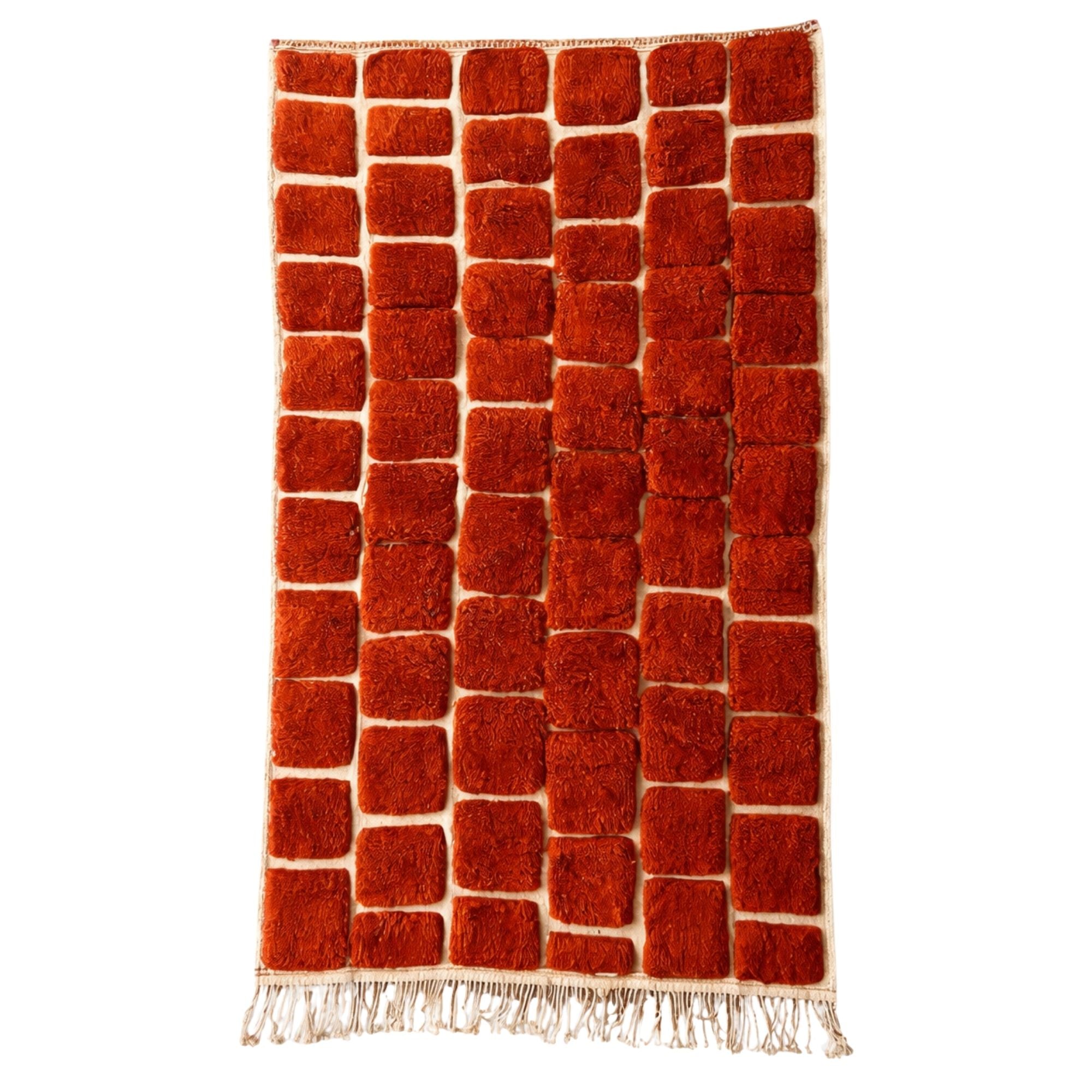 Handwoven Moroccan wool rug, Kiln design, rust-orange raised block pattern, high-pile texture, fringe edges.