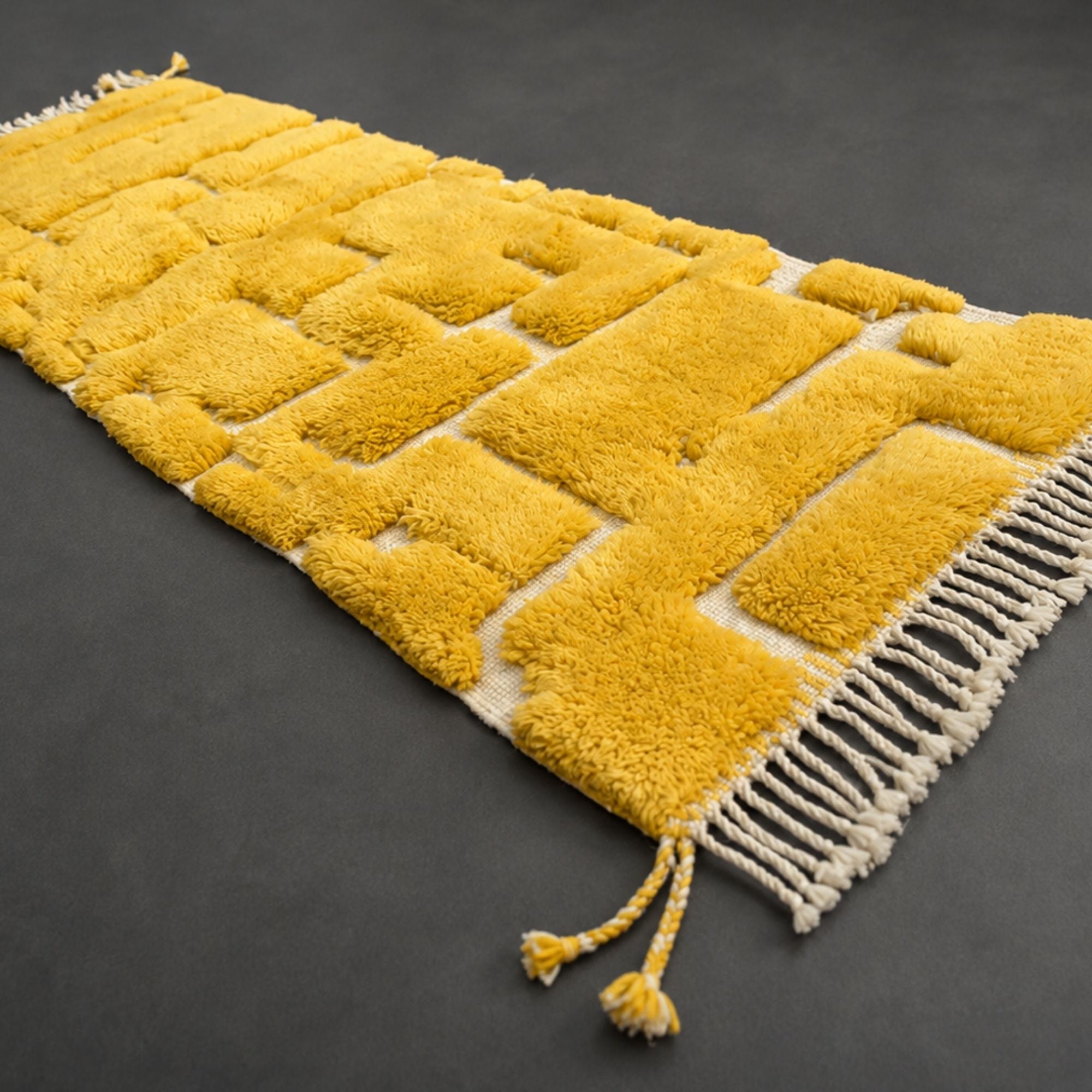 Handwoven Moroccan wool rug, Solarium design, angled view of saffron block pattern with fringe edge.