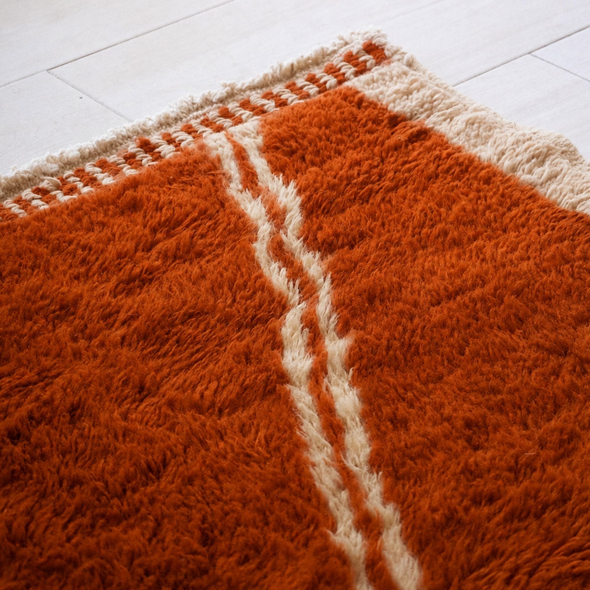 Sienna orange and ivory geometric Moroccan wool rug handmade by artisans in Morocco