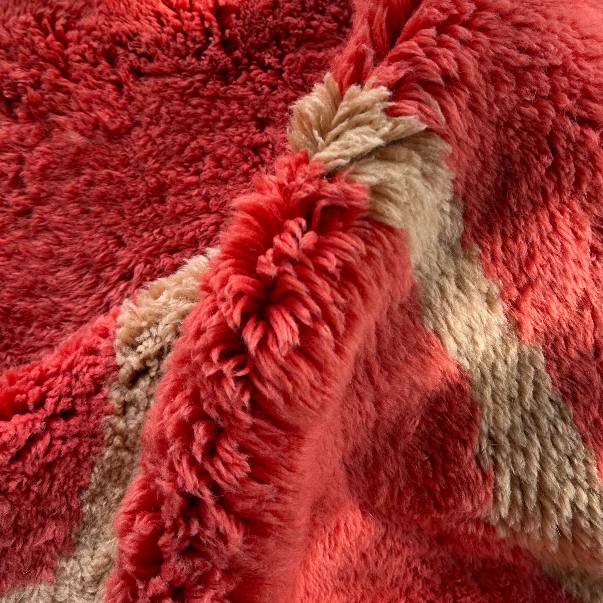 Soft and thick high-pile wool rug with organic red patterns.