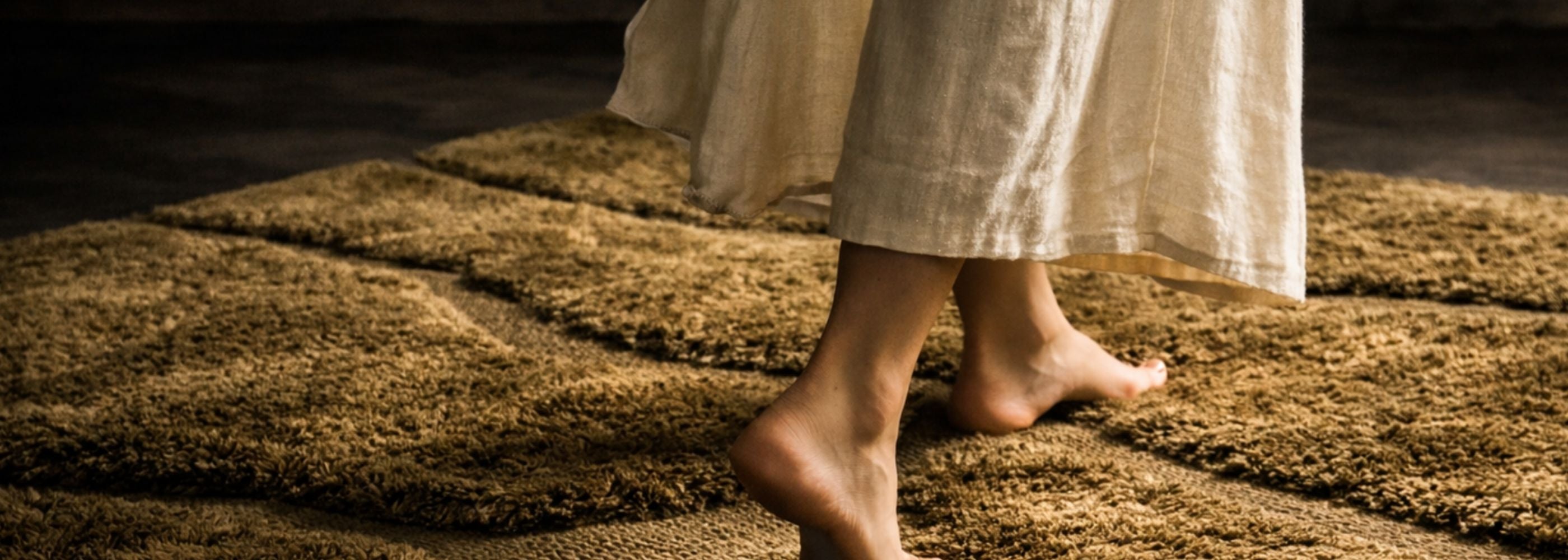 Person walking on a handwoven Moroccan Berber wool rug showcasing traditional craftsmanship from Morocco