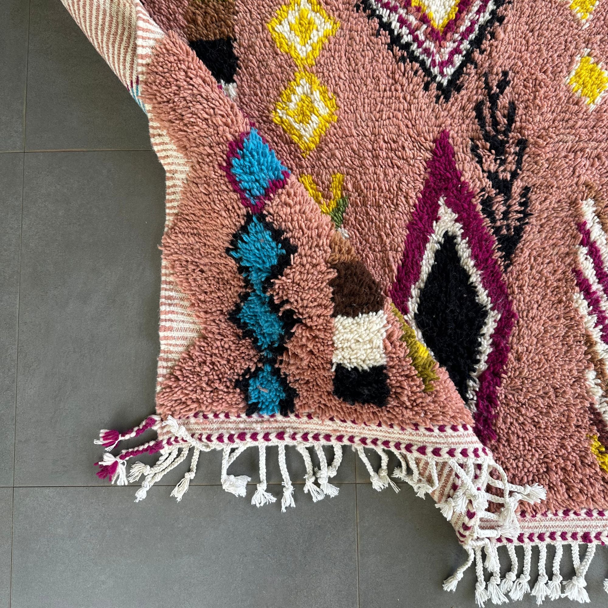 Artisan Treasures pink Moroccan rug with colorful Berber diamond tribal designs and textured sides, handwoven by Berber artisans.