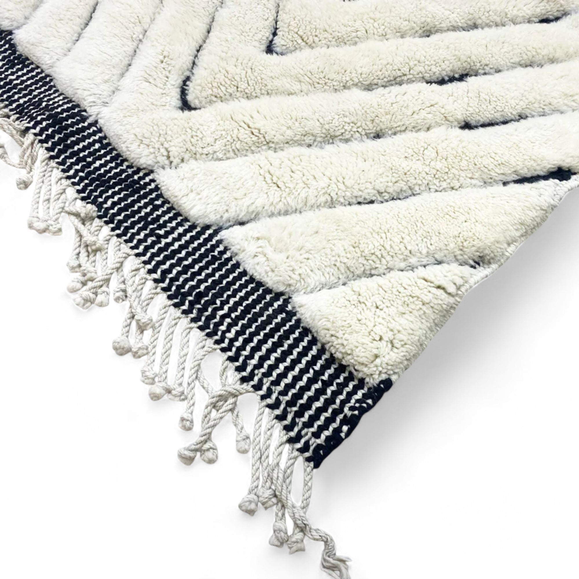 Berber Boulevards white Moroccan rug with a textured black diamond design, handwoven by Berber artisans.