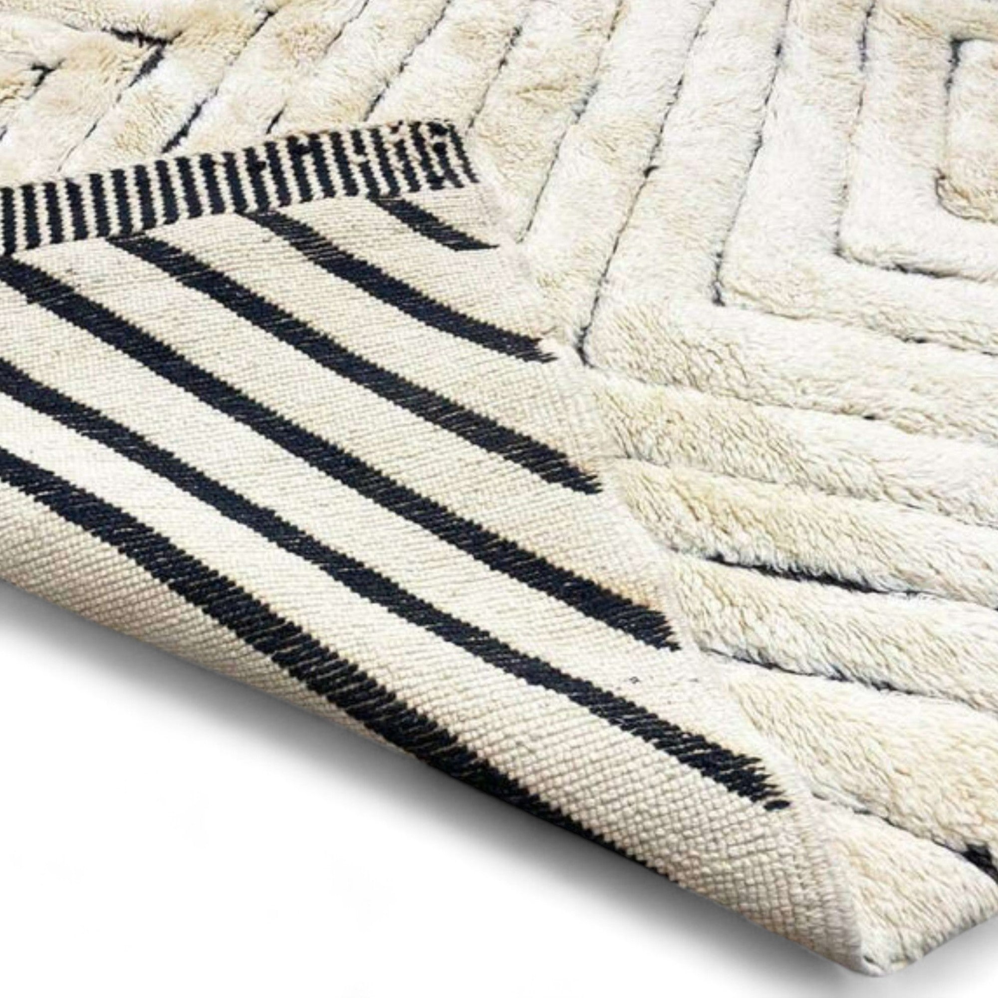 Berber Boulevards white Moroccan rug with a textured black diamond design, handwoven by Berber artisans.