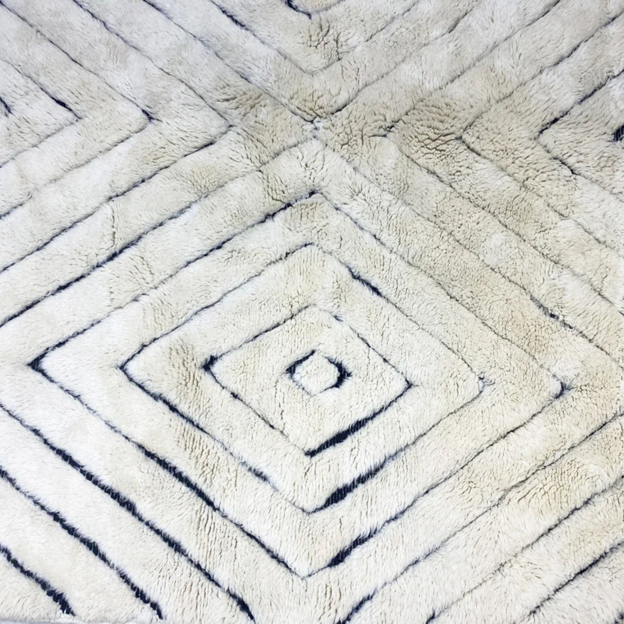 Berber Boulevards white Moroccan rug with a textured black diamond design, handwoven by Berber artisans.