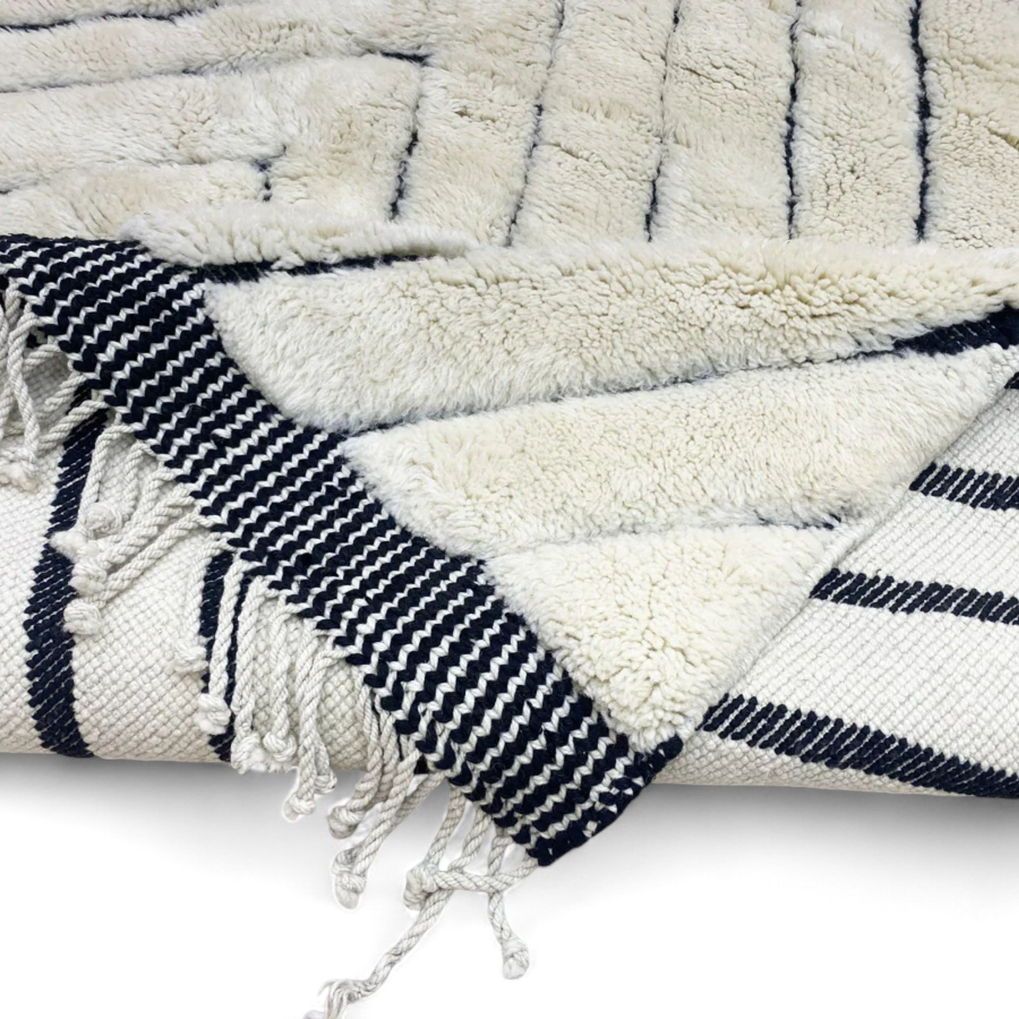 Berber Boulevards white Moroccan rug with a textured black diamond design, handwoven by Berber artisans.