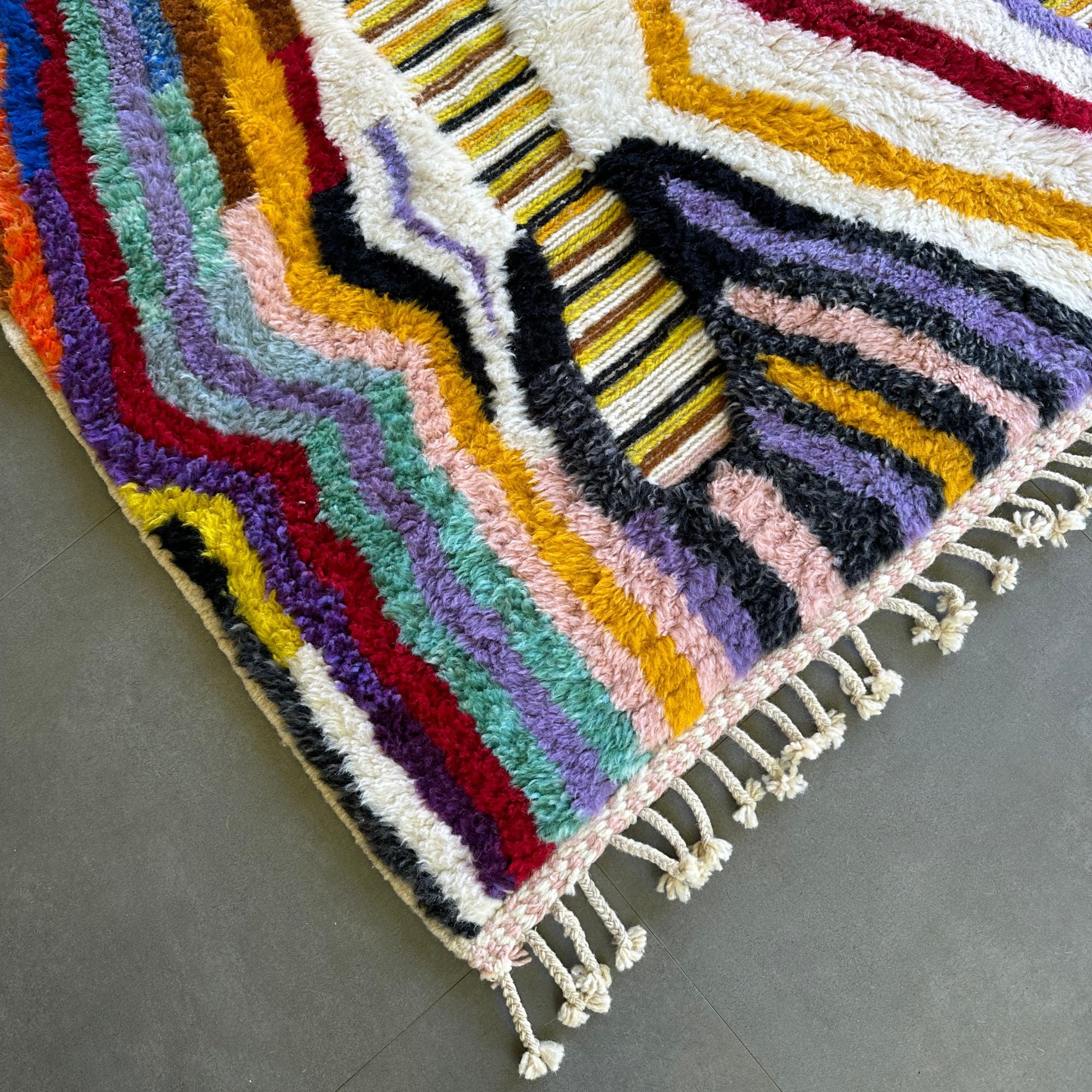 Berber Odyssey Berber area rug with a vibrant multicolor and textured design, handwoven by Berber artisans