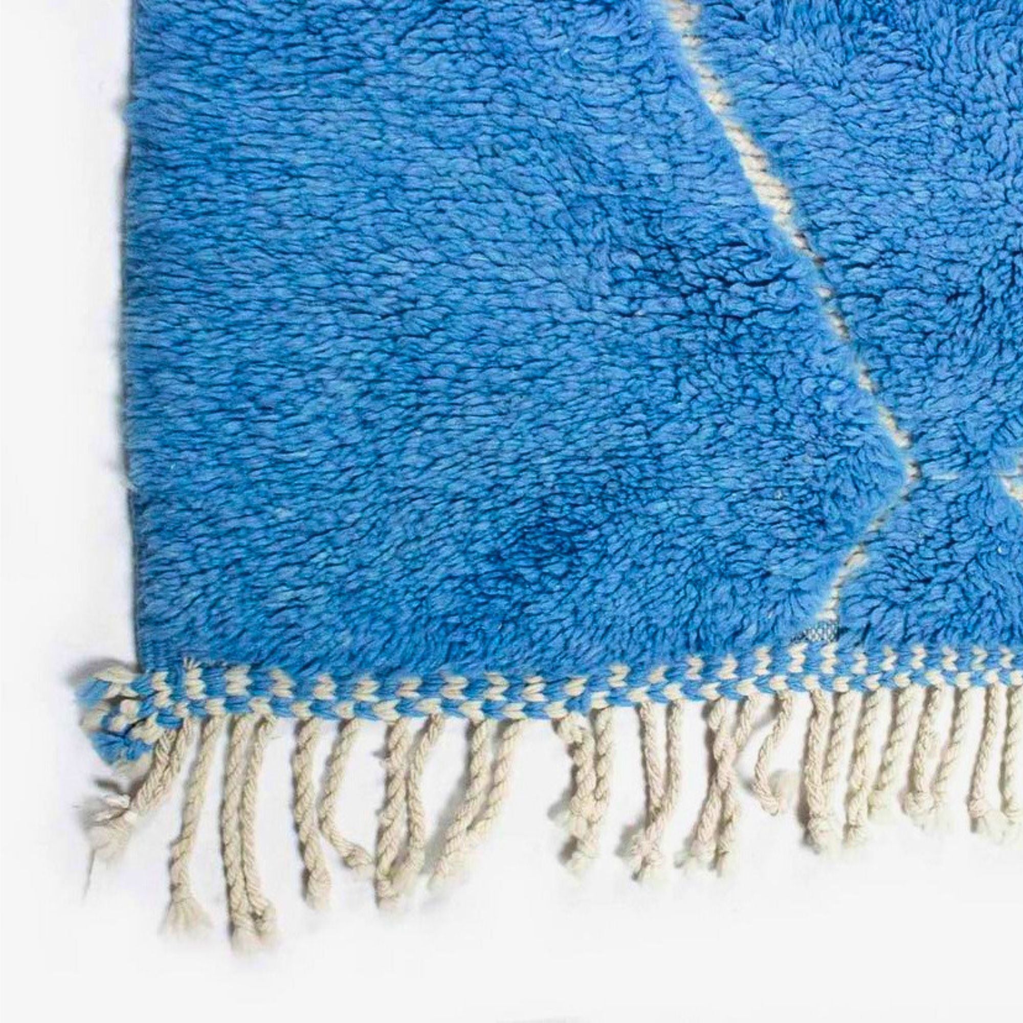 Artisan Essence blue Moroccan rug with a white diamond design, handwoven by Berber artisans