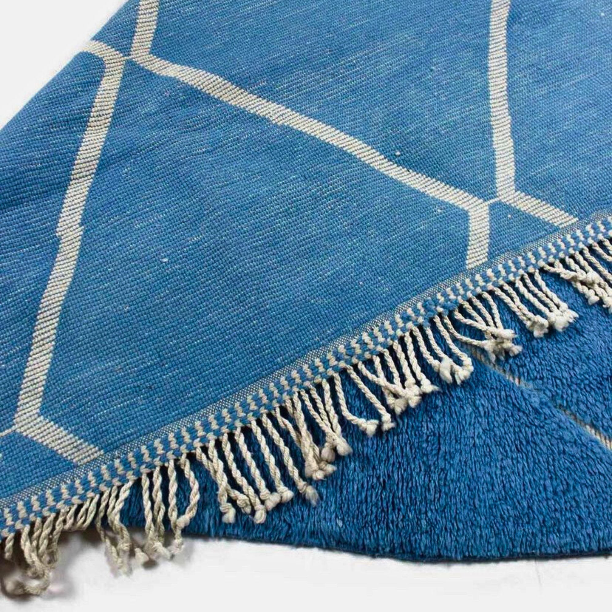 Artisan Essence blue Moroccan rug with a white diamond design, handwoven by Berber artisans