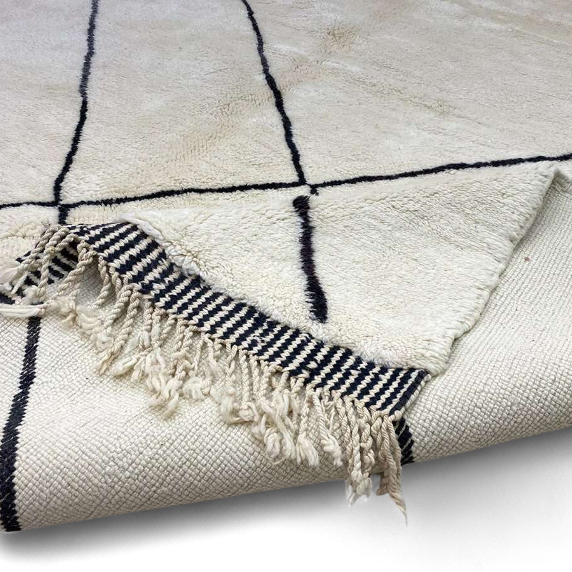 Berber Tradition white Moroccan rug with a black tribal design, handwoven by Berber artisans