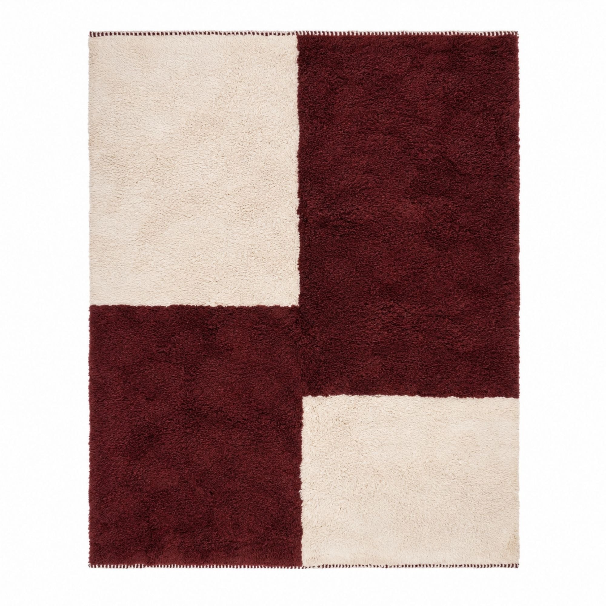 Burgundy and ivory Moroccan rug flat lay with bold geometric checkerboard design, plush high pile wool texture, and handcrafted Beni Mrirt construction photographed on a clean neutral background.
