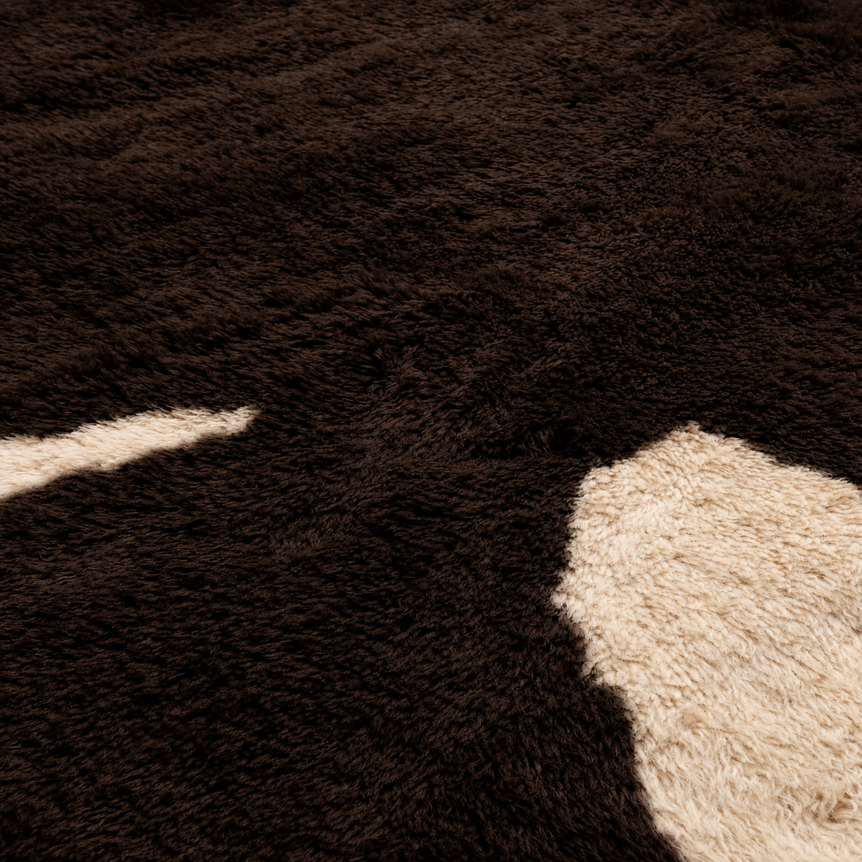 Close-up detail of Fragment No. 01 showing the deep high-pile wool texture and ivory abstract motif.