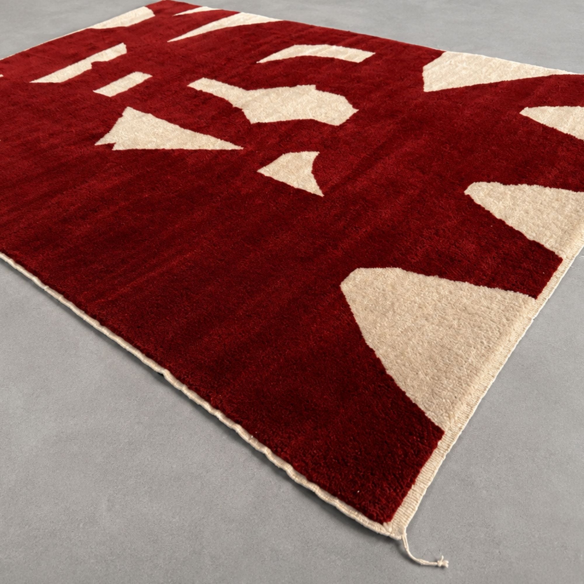 Close-up detail of ivory geometric fragments on Fragment No. 02 Moroccan wool rug.