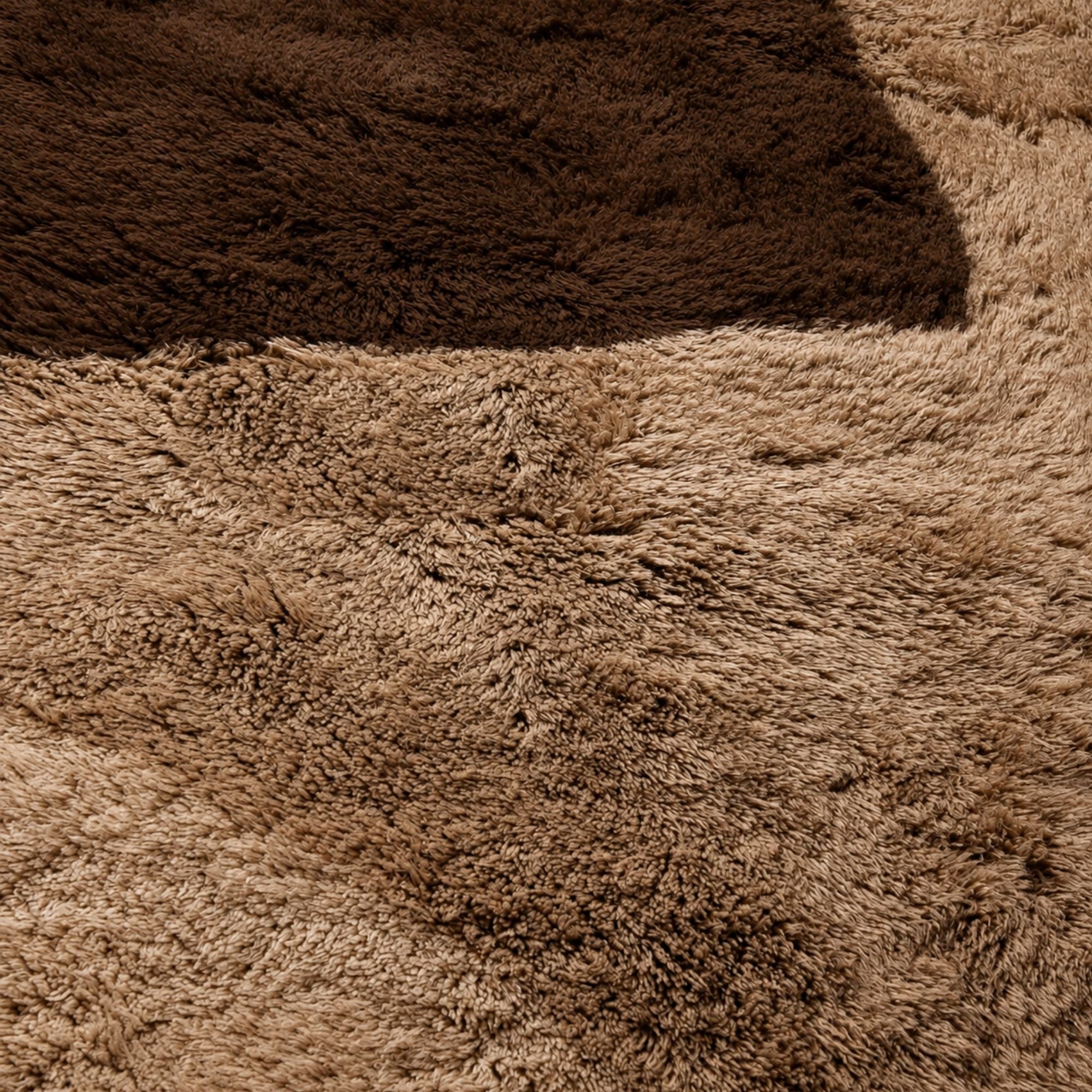 Close-up of the plush high-pile Moroccan rug showing dense wool texture, natural tonal variation, and rich espresso brown geometric detailing.