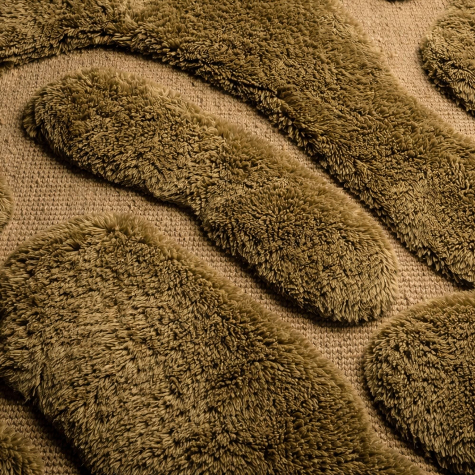 Close-up of Contour No. 01 rug showing dense olive wool pile and raised organic shapes over flat-woven base.