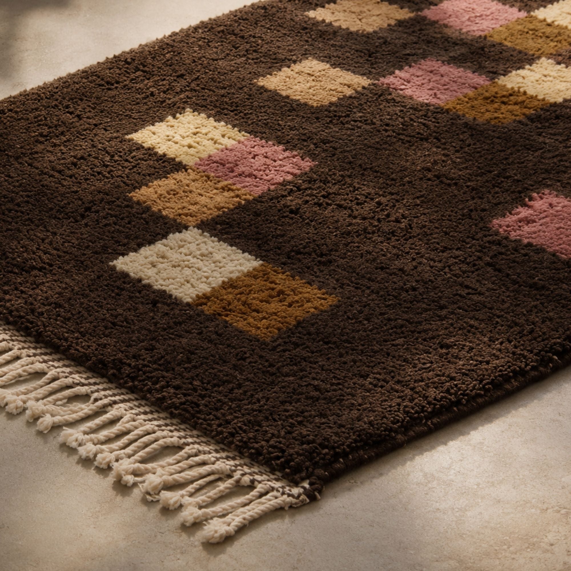 Close-up of handmade Moroccan wool rug in chocolate brown camel ivory and dusty rose
