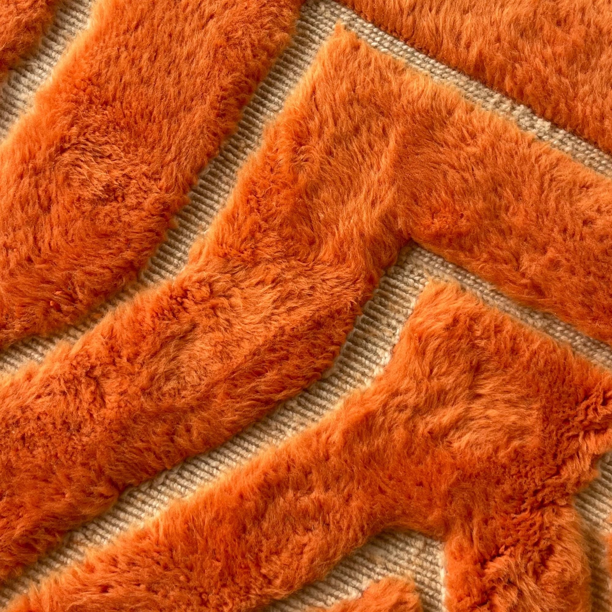 Close-up showing the flowing geometric pattern and handmade high-low construction of Sahara Symphony No. 01.