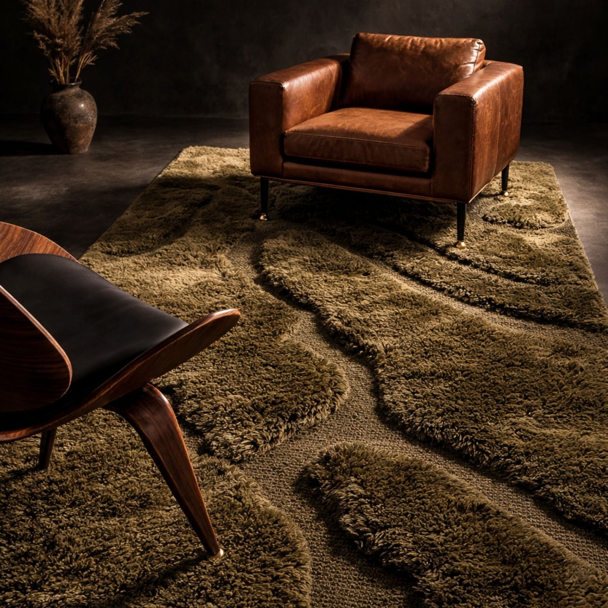 Contour No. 01 Moroccan rug styled with leather armchair and warm lighting, highlighting its sculptural wool texture and organic contours.