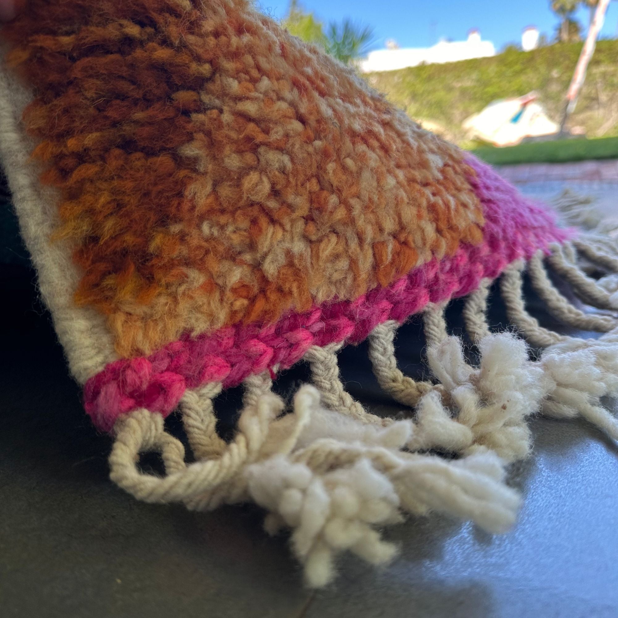 Desert Dance handmade wool rug in stock with a pink base and multicolor design, featuring Berber women's secret language, handwoven by Berber artisans