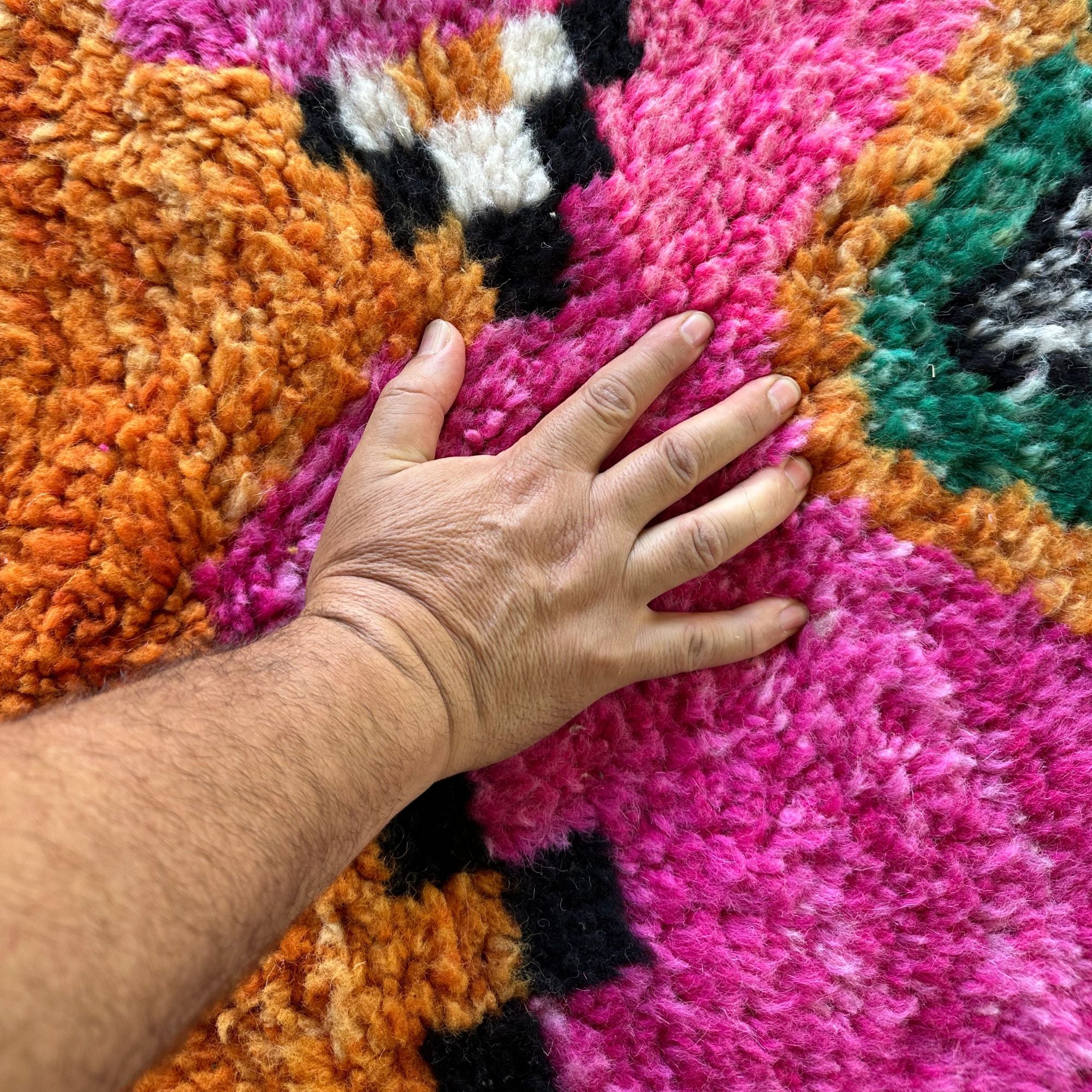 Desert Dance handmade wool rug in stock with a pink base and multicolor design, featuring Berber women's secret language, handwoven by Berber artisans