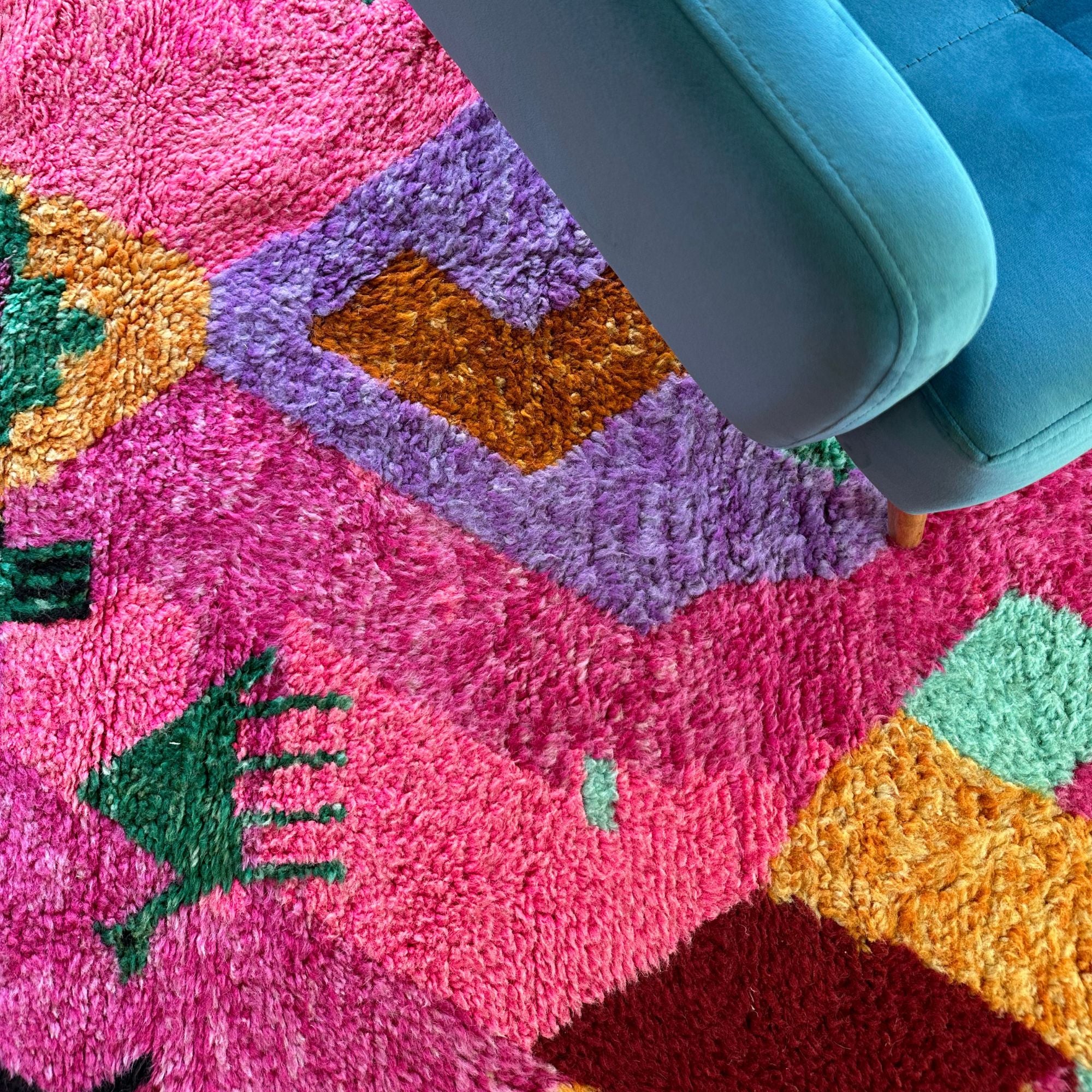 Desert Dance handmade wool rug in stock with a pink base and multicolor design, featuring Berber women's secret language, handwoven by Berber artisans