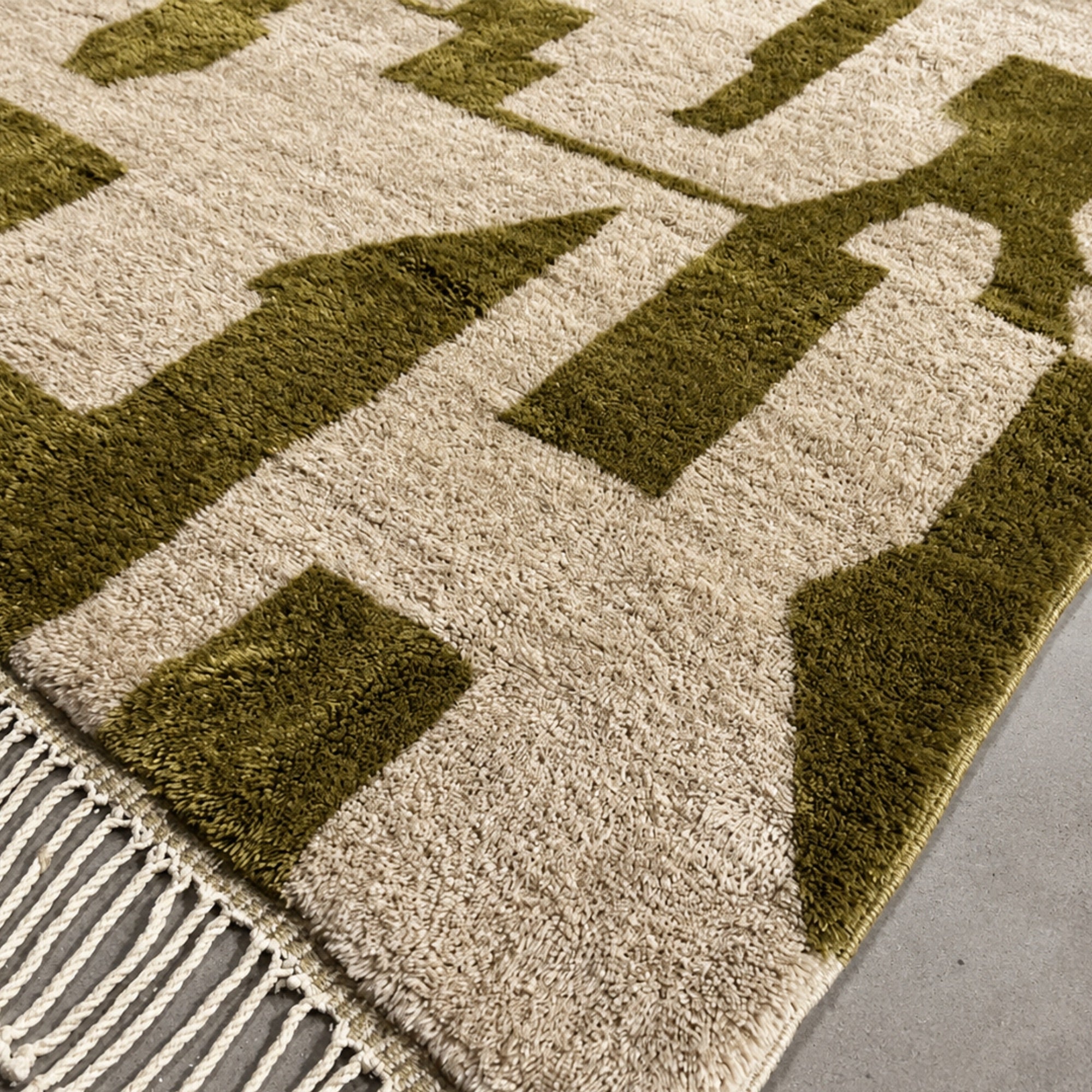 Detail of Relic handmade Moroccan wool rug corner showing fringe and fragmented geometric pattern.