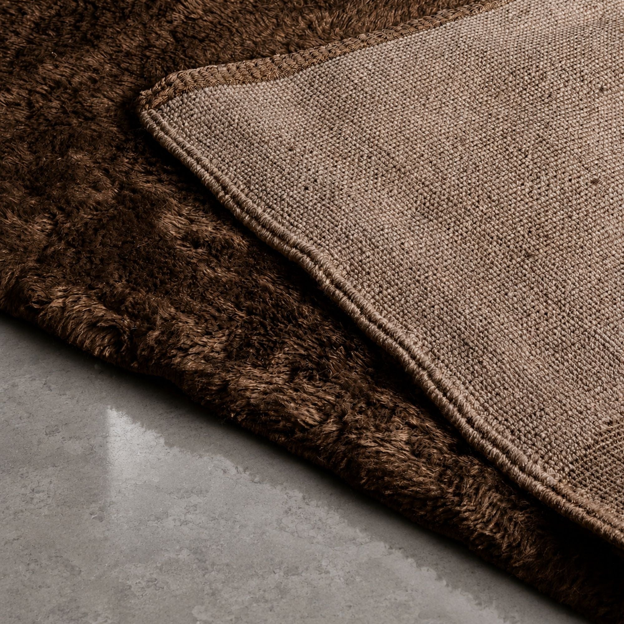 Detailed view of the underside and edge finishing of a handmade Moroccan Berber rug with thick wool pile and artisanal woven construction.
