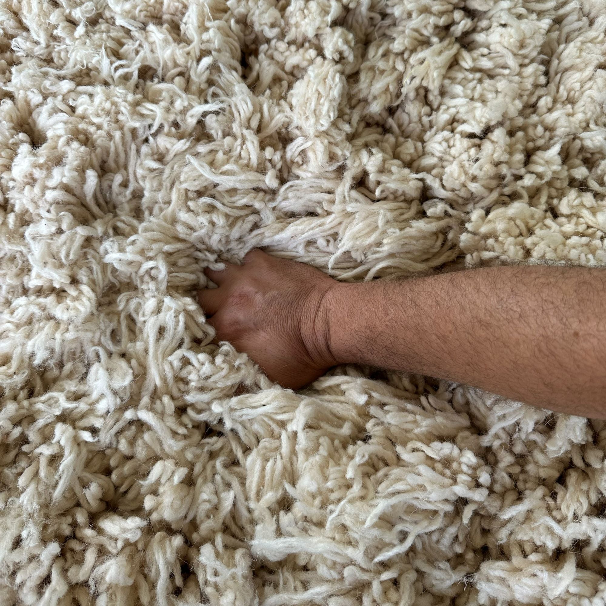 Detailed macro texture of Halo Round Rug highlighting soft natural wool fibers, artisan handwoven pile, and luxurious tactile finish.