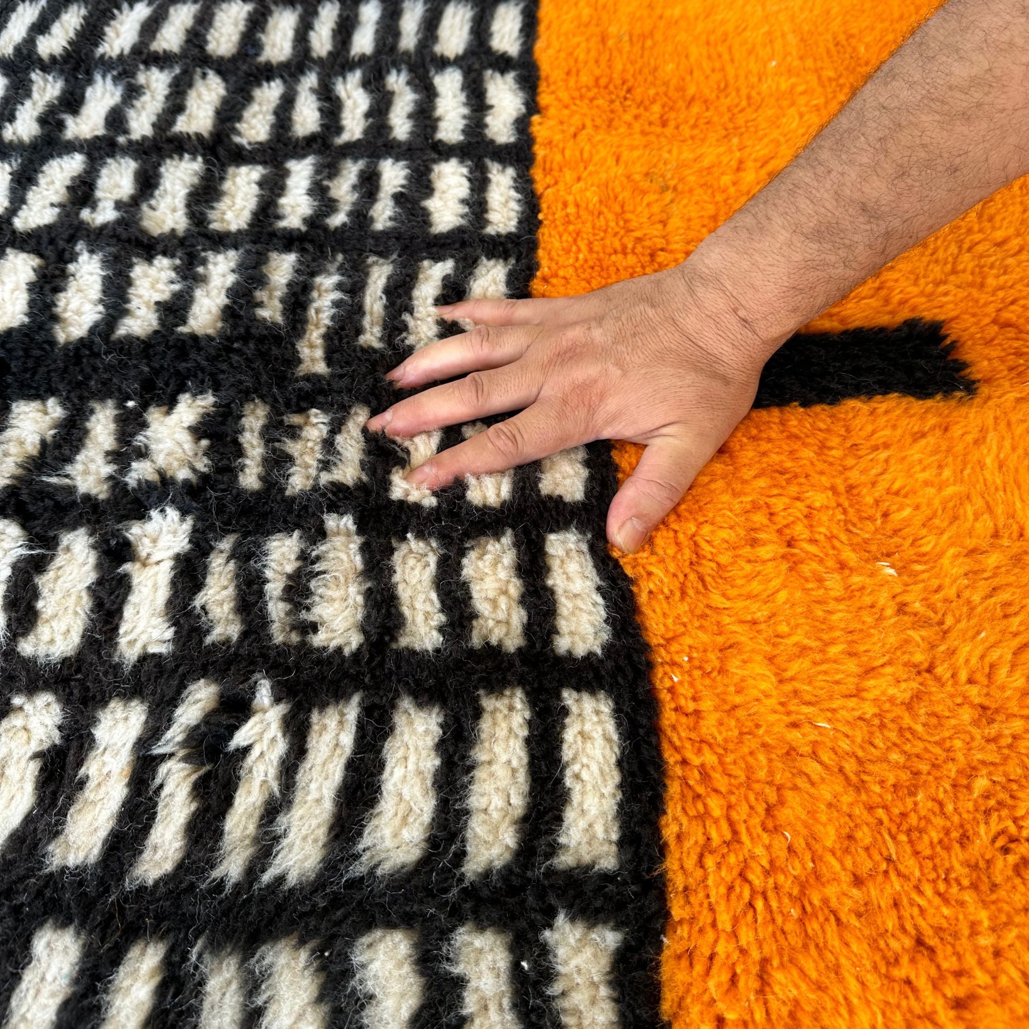 Enchanted Echo 3 foot wide runner rug with an orange and white color scheme and a tribal Berber design in the middle, handwoven by Berber artisans