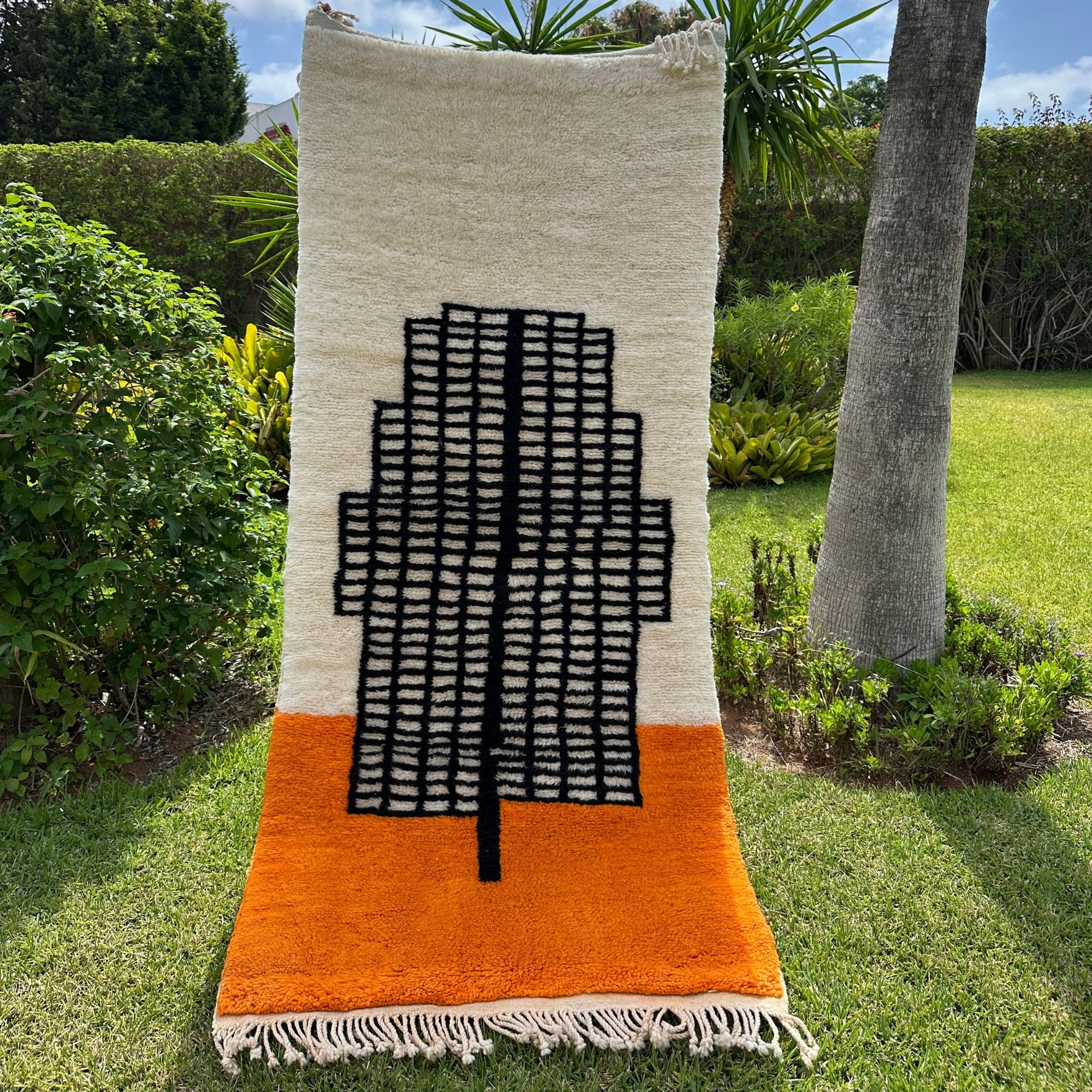 Enchanted Echo 3 foot wide runner rug with an orange and white color scheme and a tribal Berber design in the middle, handwoven by Berber artisans
