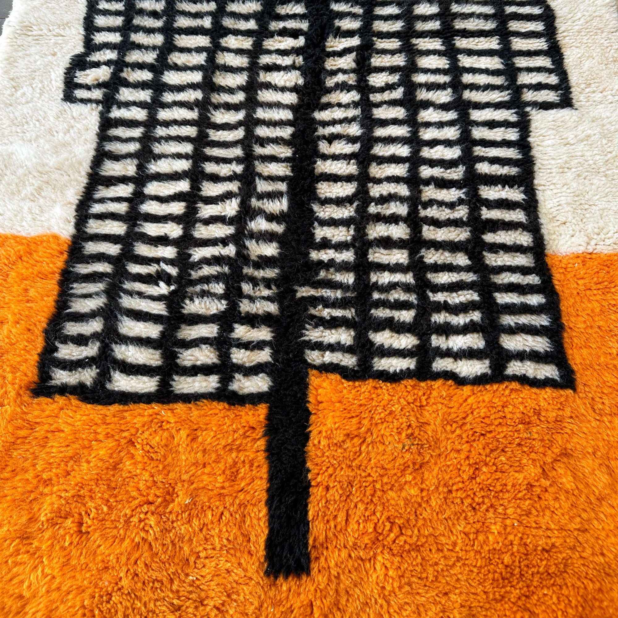 Enchanted Echo 3 foot wide runner rug with an orange and white color scheme and a tribal Berber design in the middle, handwoven by Berber artisans