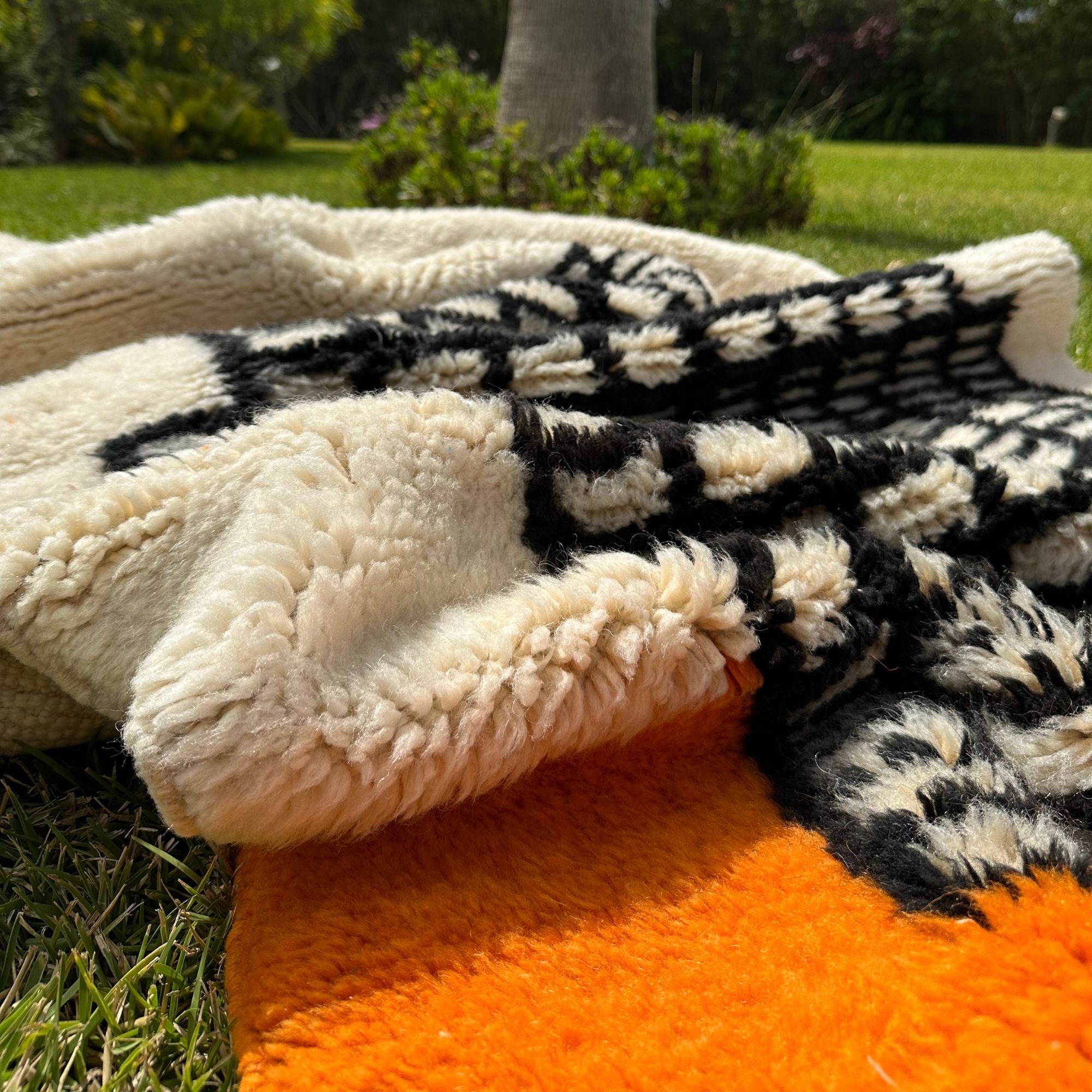 Enchanted Echo 3 foot wide runner rug with an orange and white color scheme and a tribal Berber design in the middle, handwoven by Berber artisans
