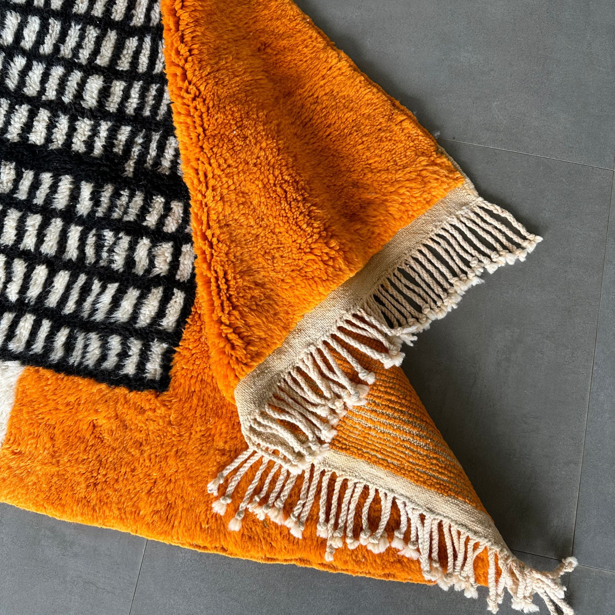 Enchanted Echo 3 foot wide runner rug with an orange and white color scheme and a tribal Berber design in the middle, handwoven by Berber artisans