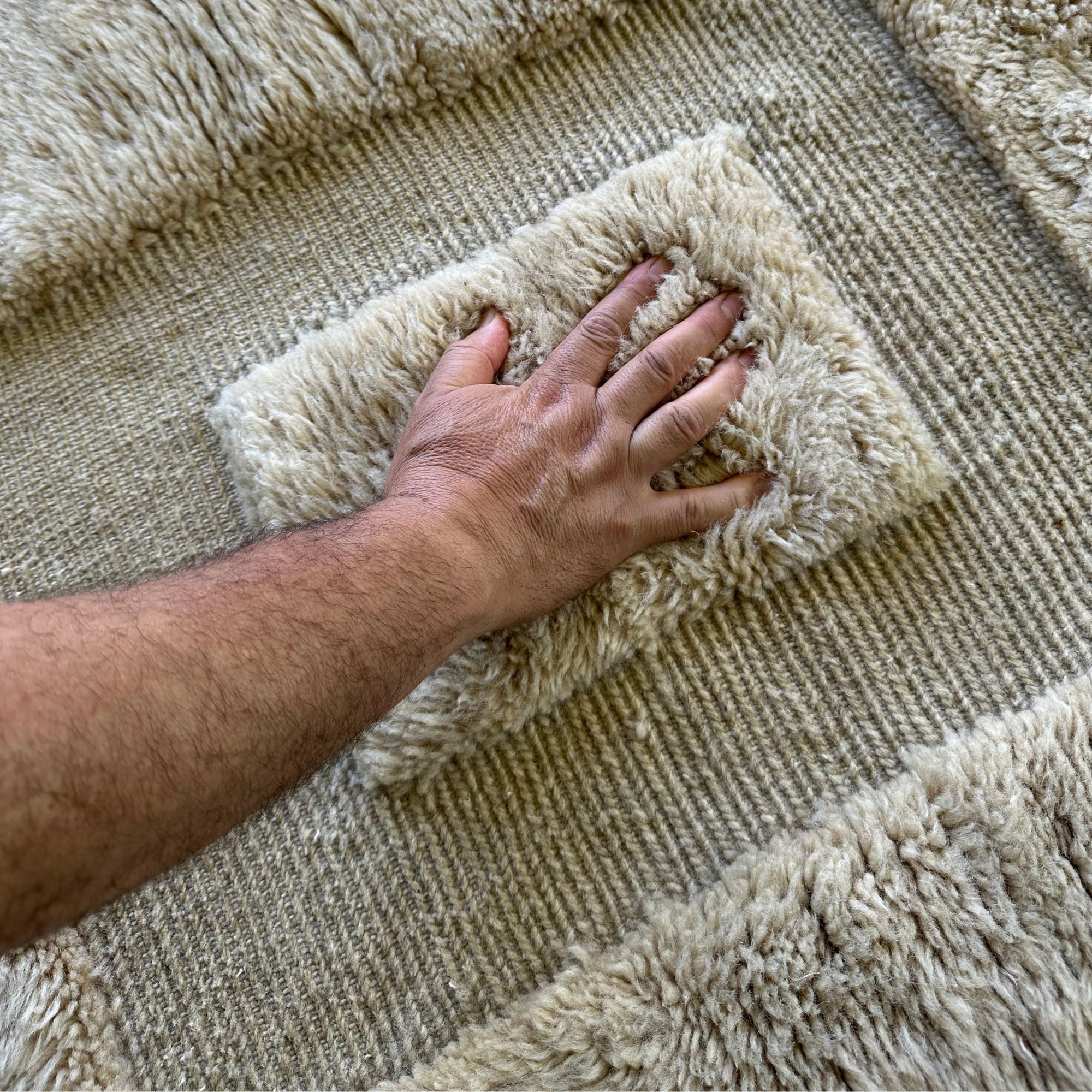 Enchanted Echo Berber area rug with a textured design featuring two larger squares with smaller squares inside, handwoven by Berber artisans