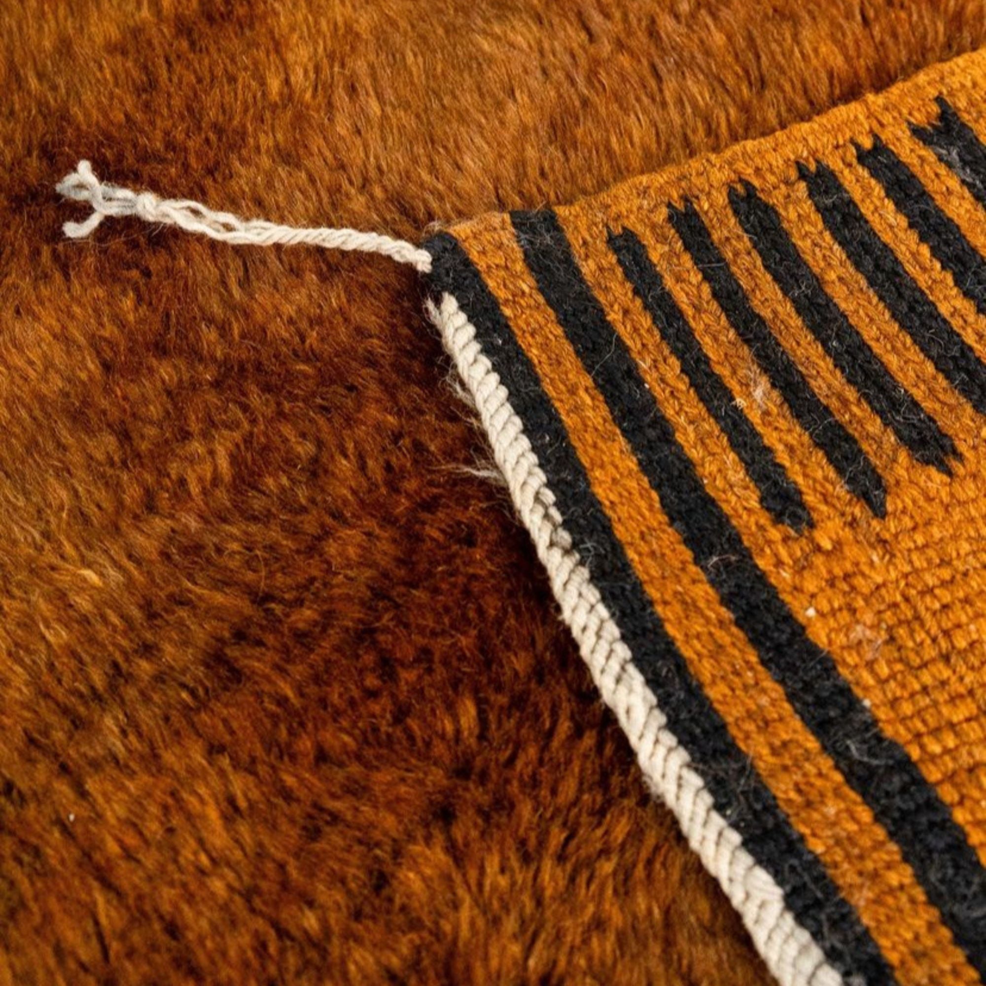 Ethereal Embrace high pile Moroccan rug with a brown base, black stripes, and flat edges, handwoven by Berber artisans