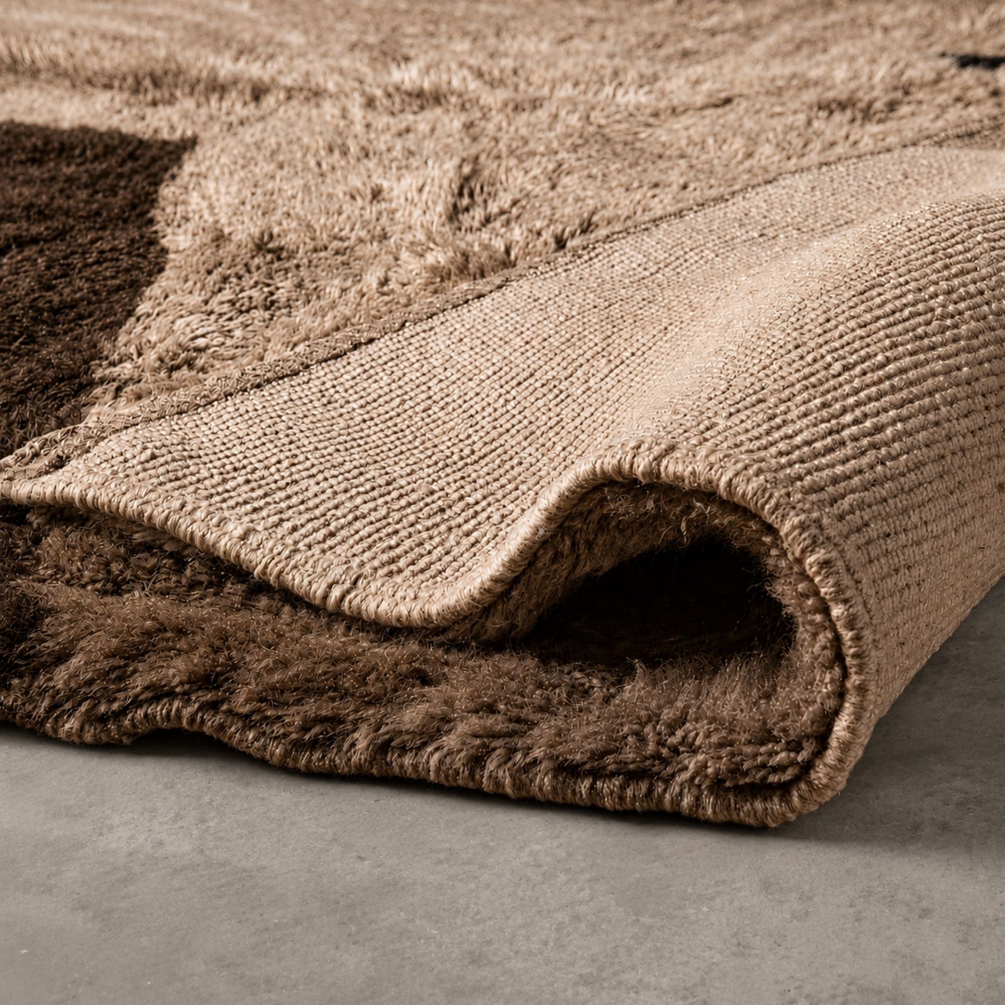 Folded corner detail of a handmade Moroccan Berber rug showing thick wool pile, organic texture, and artisan finishing.