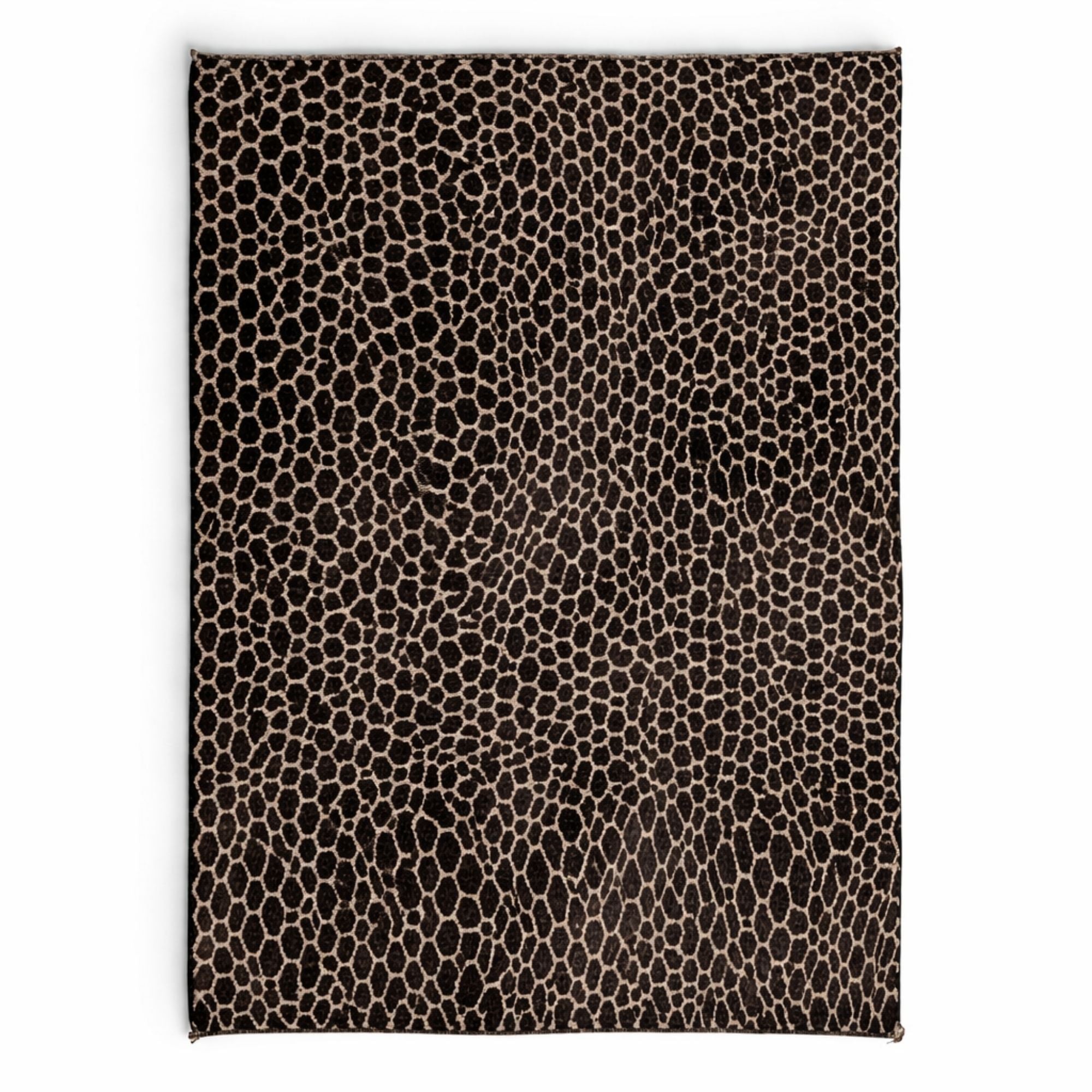 Handmade Moroccan Beni Mrirt rug featuring an organic pebble-inspired pattern in black wool on an ivory background. High-pile texture with irregular artisan shapes, photographed as a full flat lay on a neutral background.