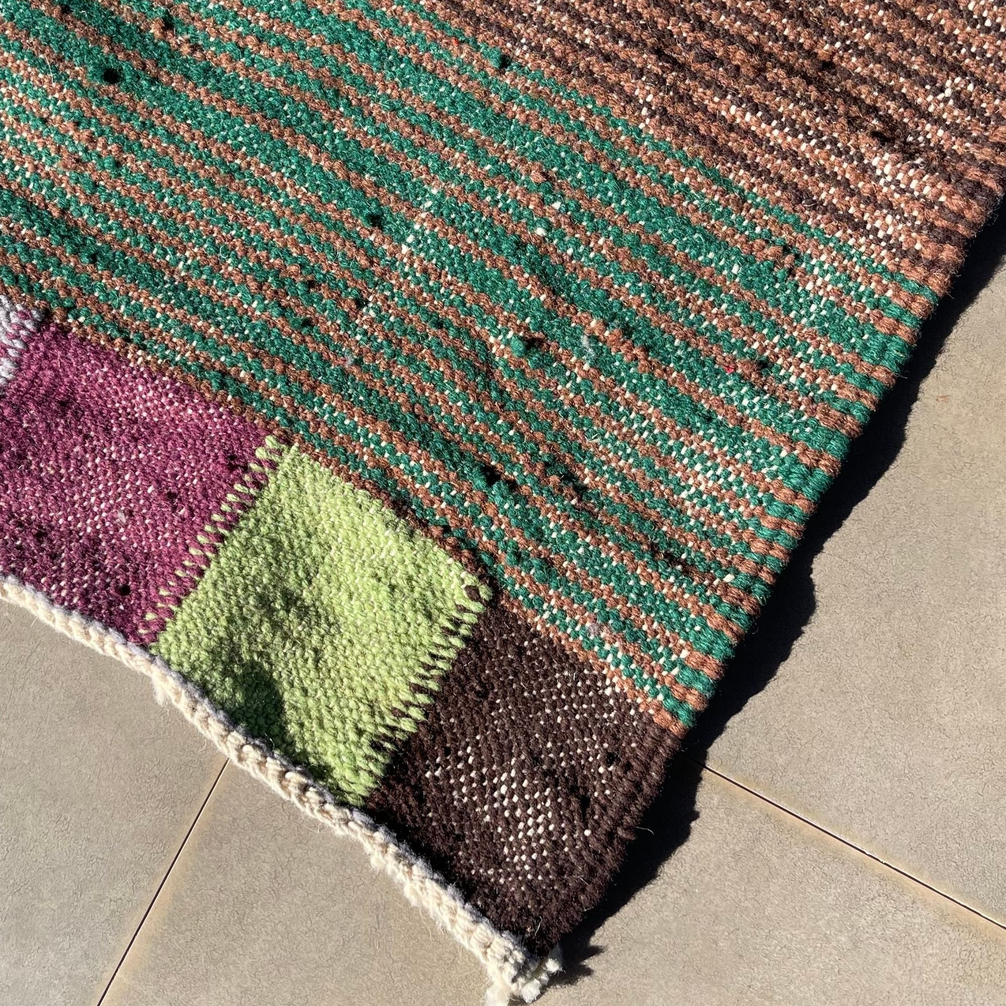 Handwoven Moroccan flatweave wool rug with colorful patchwork pattern and artisanal texture