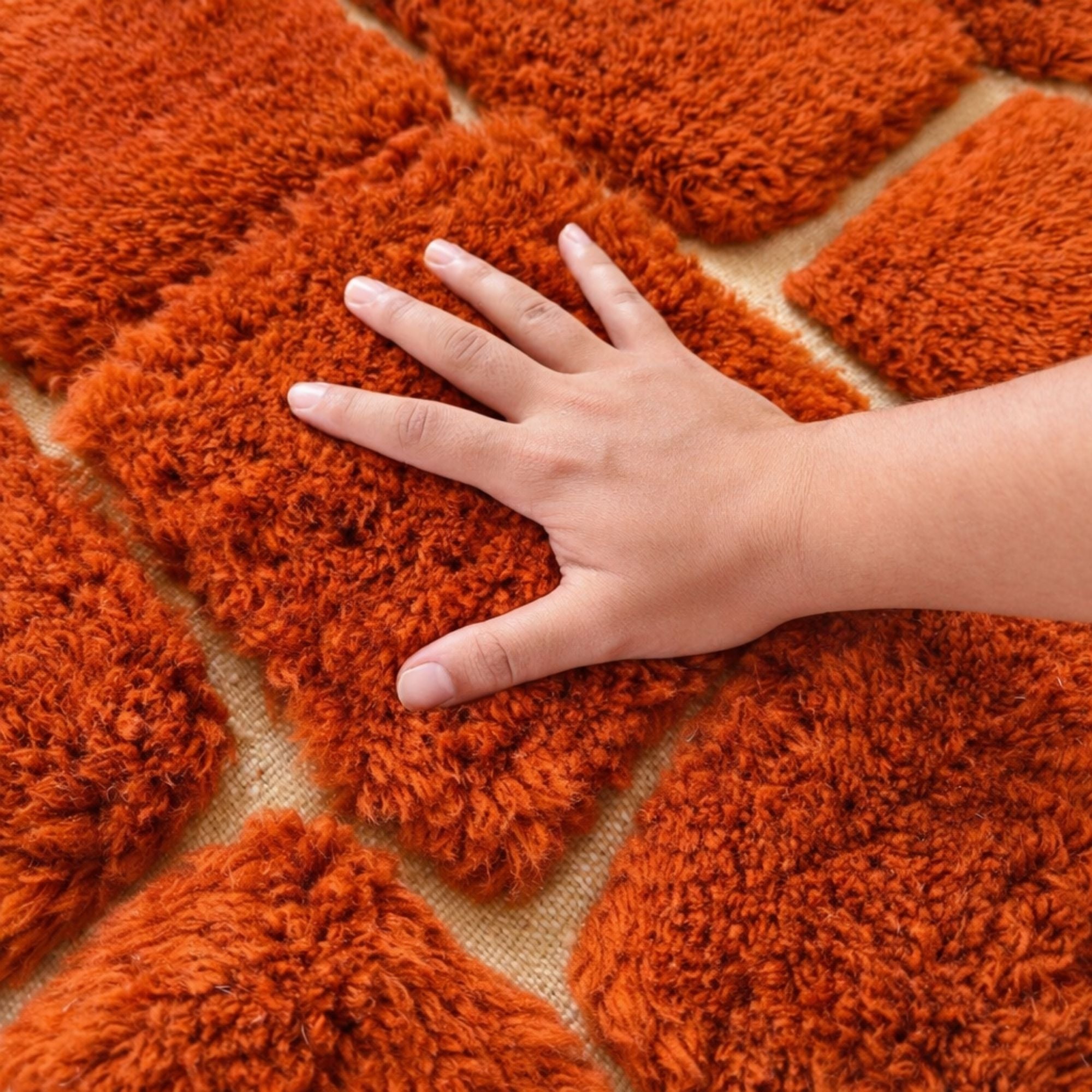Handwoven Moroccan wool rug, Kiln design, close-up of high-pile rust-orange wool texture.