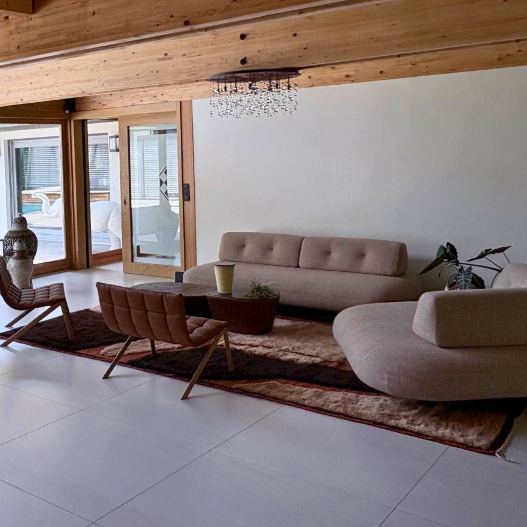 Handwoven Moroccan wool rug, Totem no. 01 design styled beneath a living room seating arrangement.